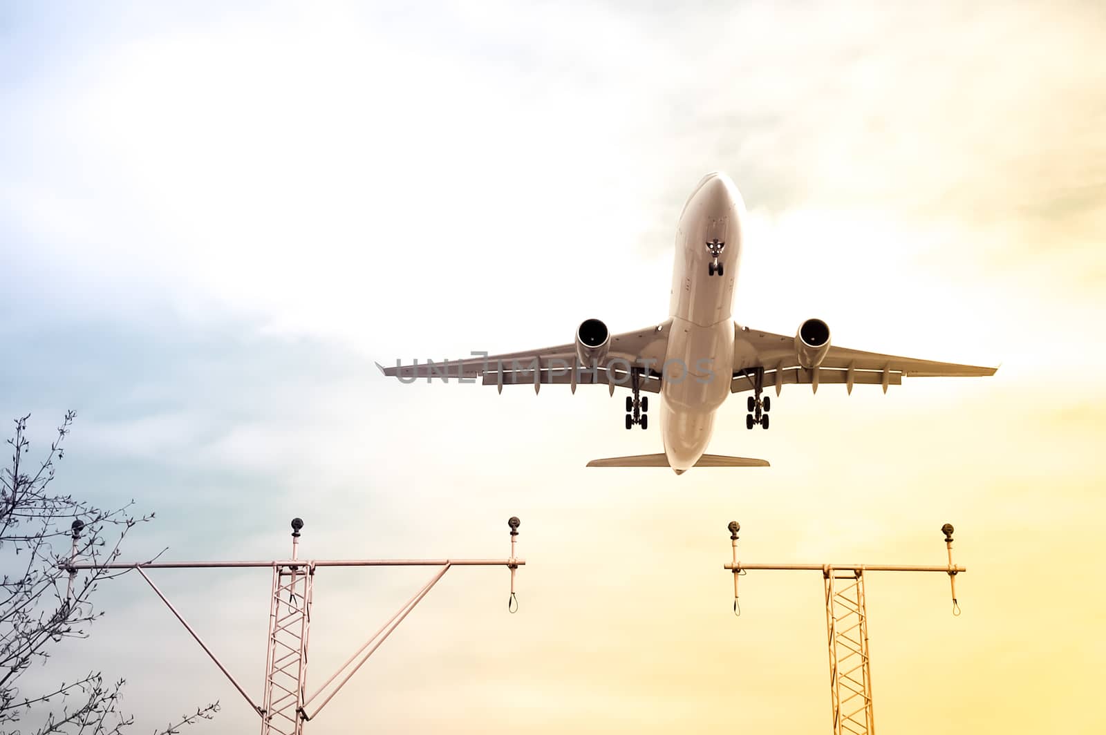 gradient toned passenger jet on landing approach to an airport