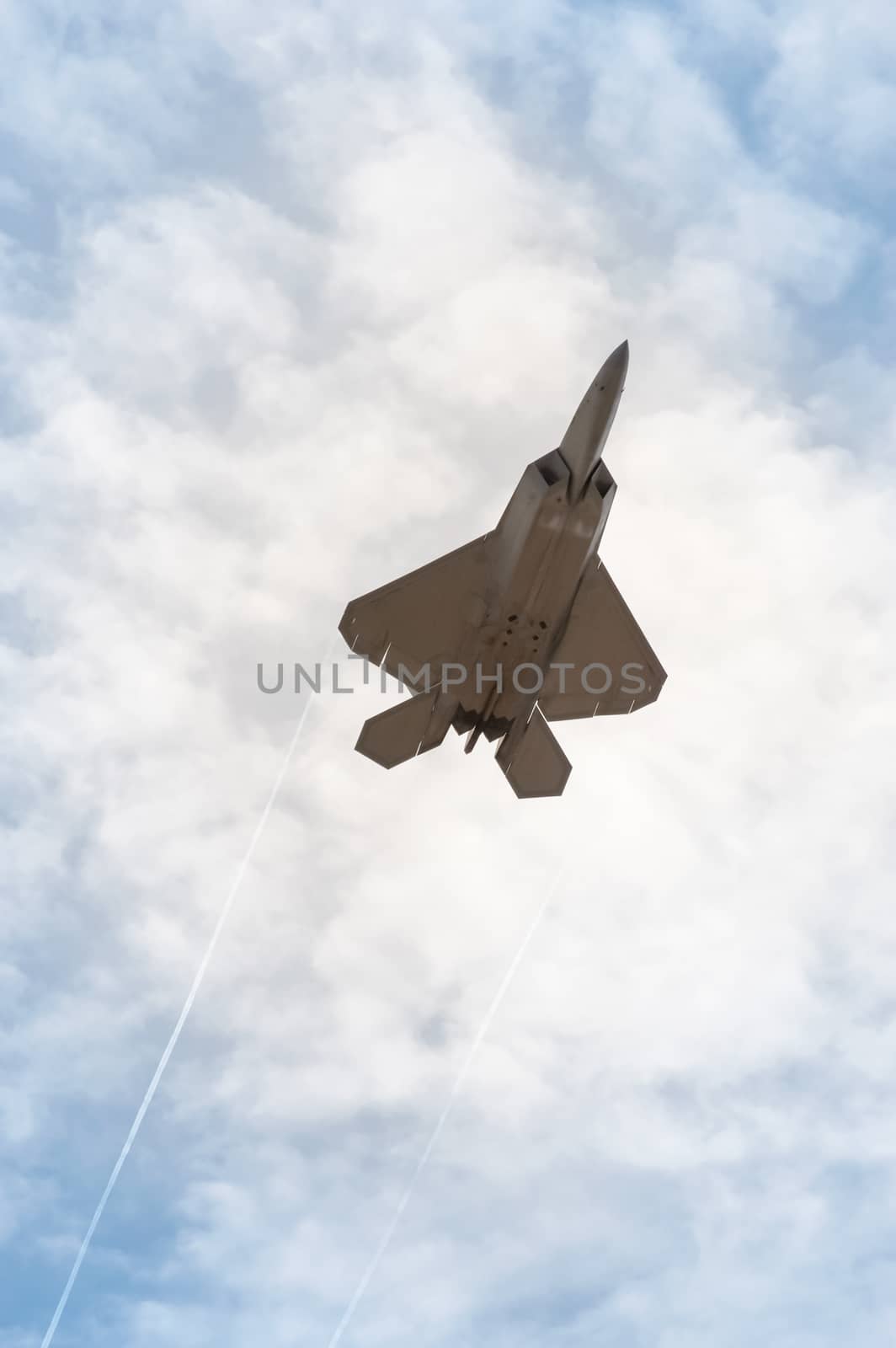 military stealth fighter speeding through the sky