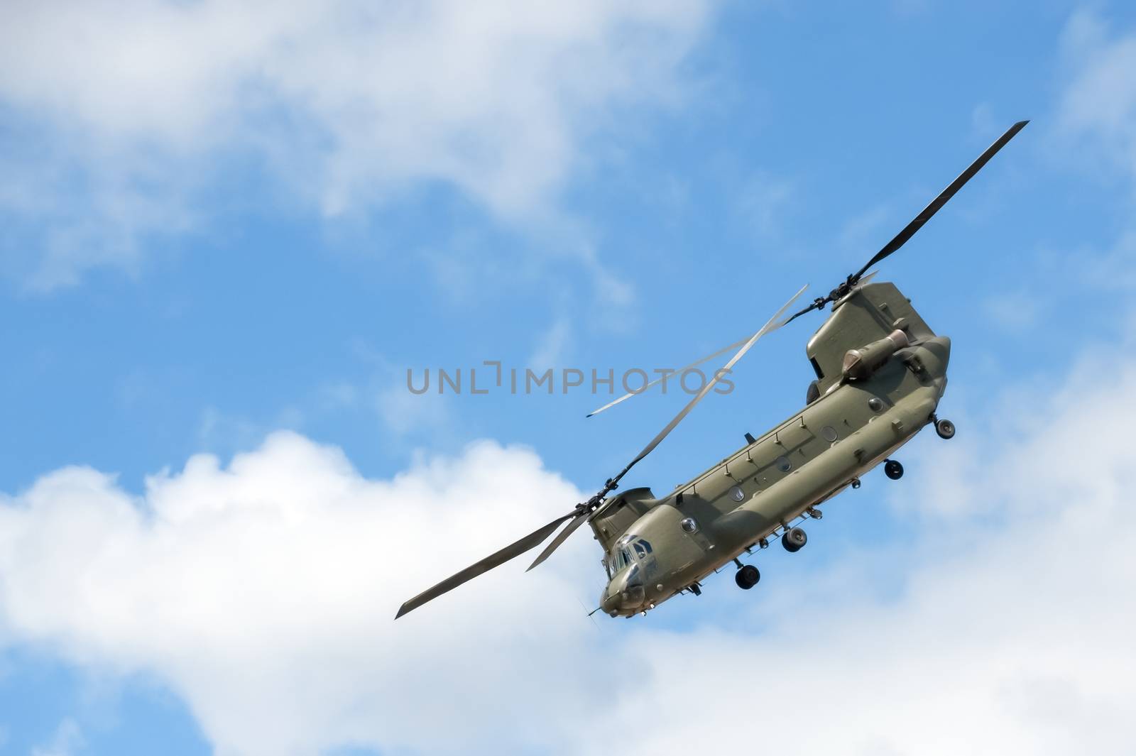 military helicopter in a steep flight maneuver