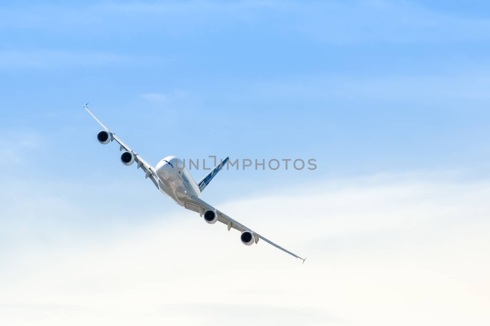 Farnborough, UK - July 19, 2010: Airbus A380 making a sweeping turn through hazy sunshine at the Farnborough Airshow, UK