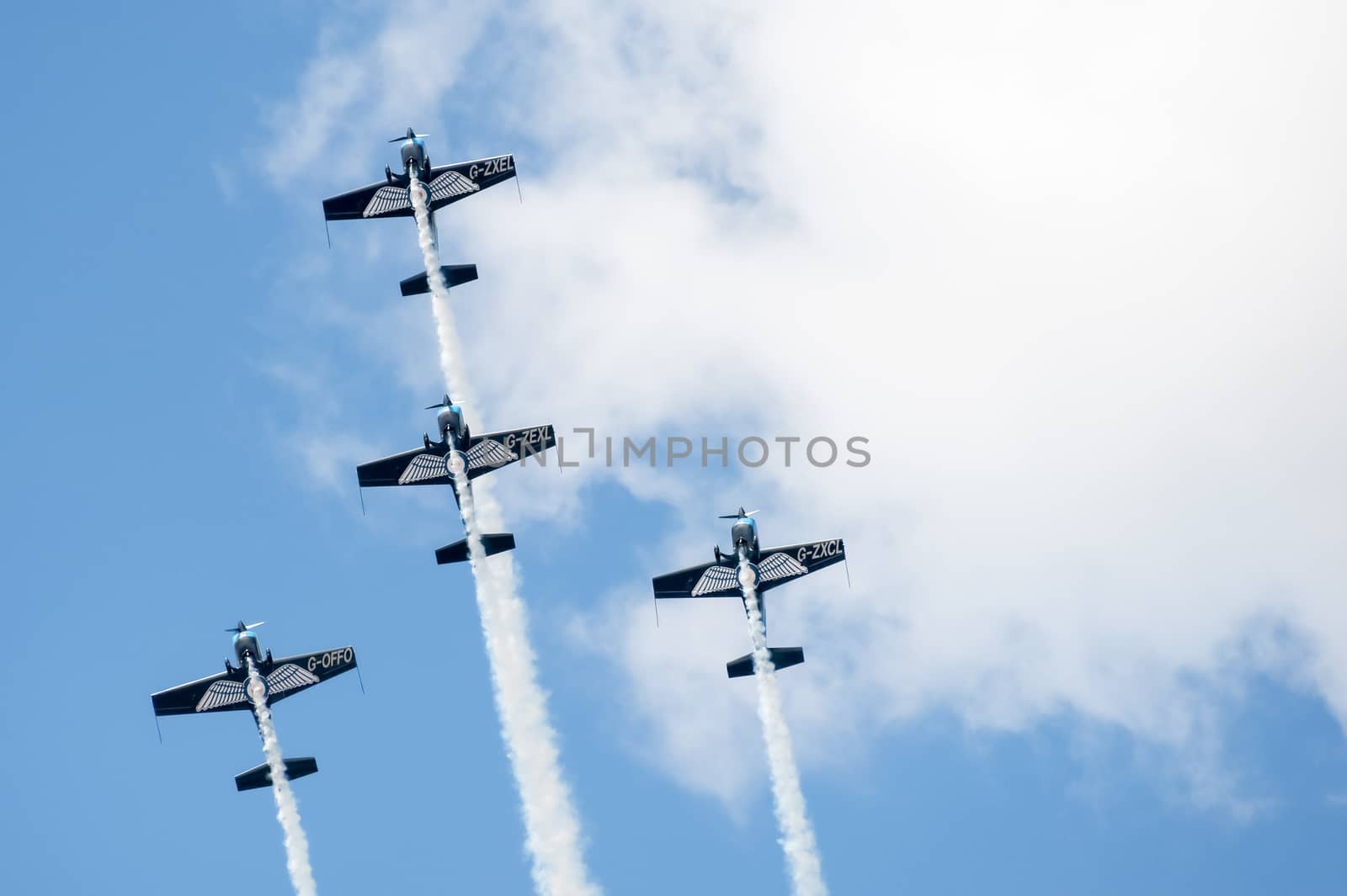 Farnborough, UK - July 24, 2010: The Blades aerobatics team performing a tight formation maneuver at the Farnborough Airshow, UK