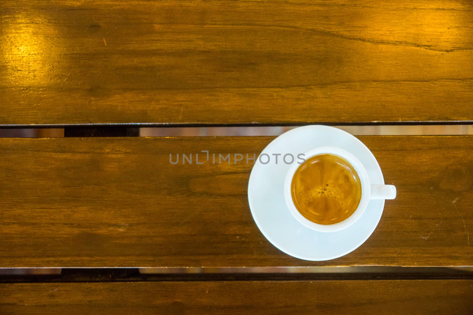 one of espresso cup on wooden table,shallow focus