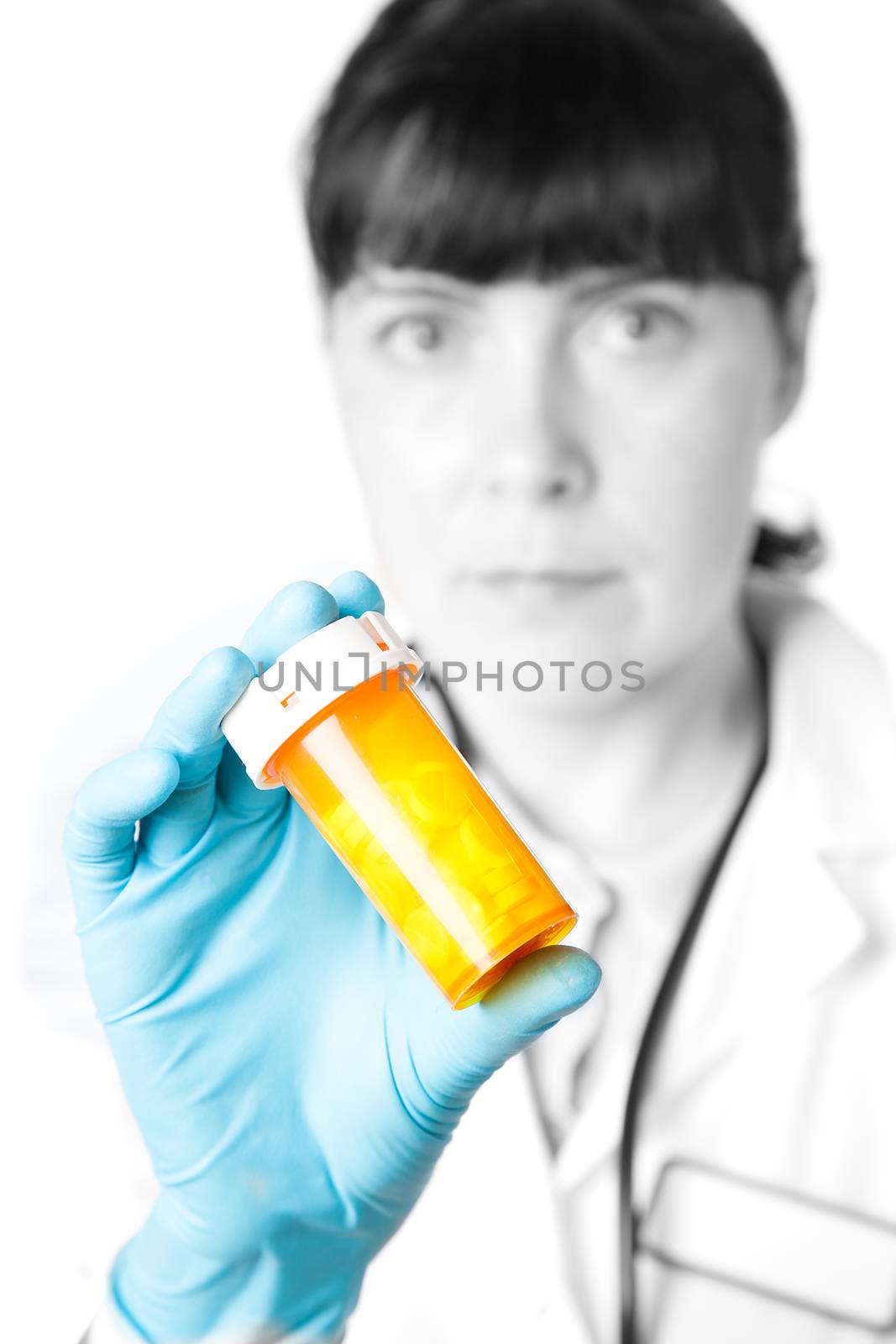 Doctor or pharmacist holding a bottle of pills by motorolka