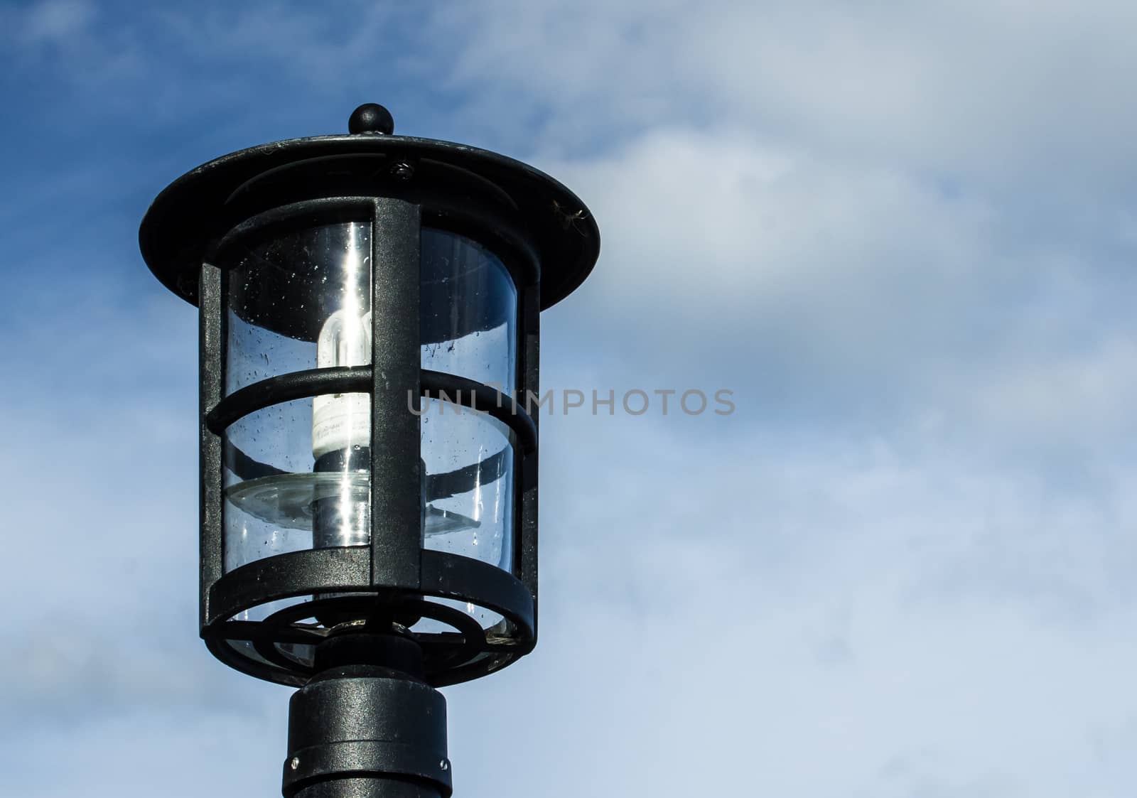 Lamp against the cloudy skies by Alexanderphoto