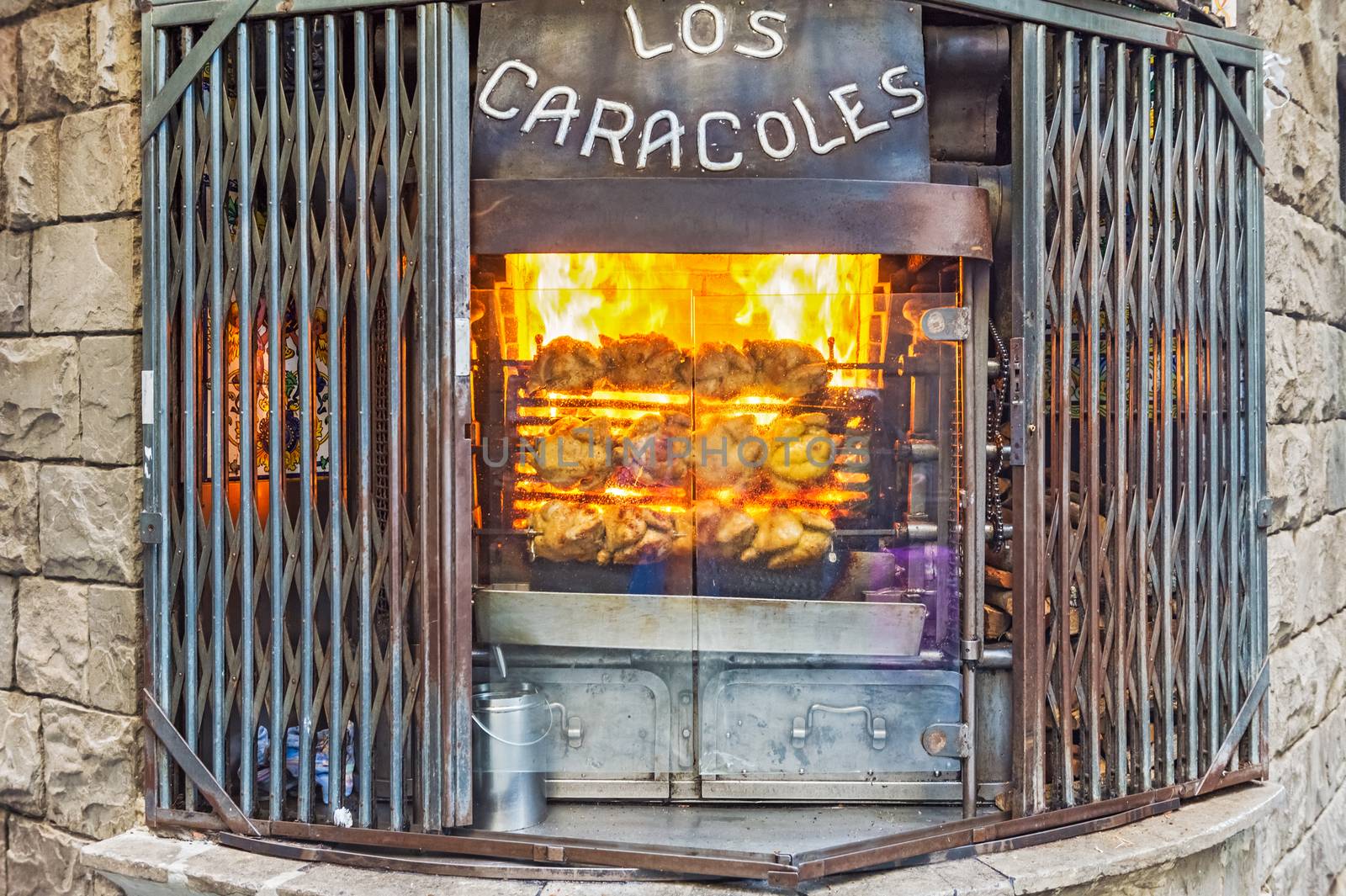 Barcelona, Spain - April 6, 2014: Front window of los Caracoles restaurant. In 1835, the Bofarull family founded one of the most charismatic restaurants in the city, in the Gothic District, near Las Ramblas in Barcelona. 