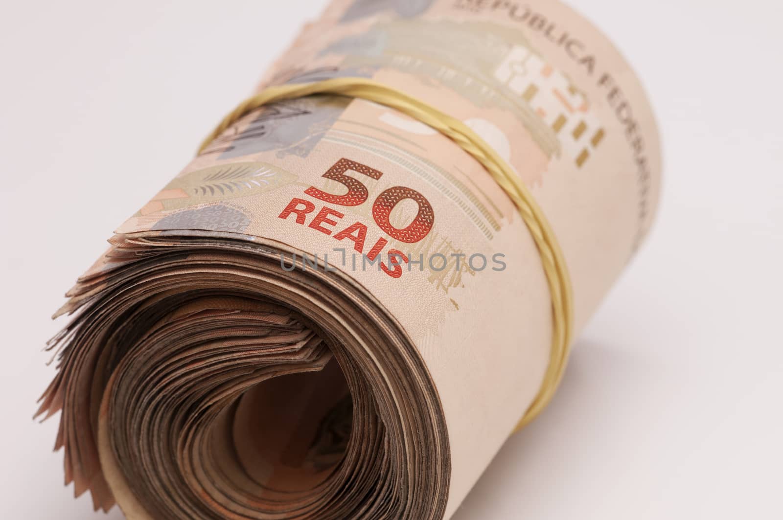 A few bills of brazilian currency (real) on white background
