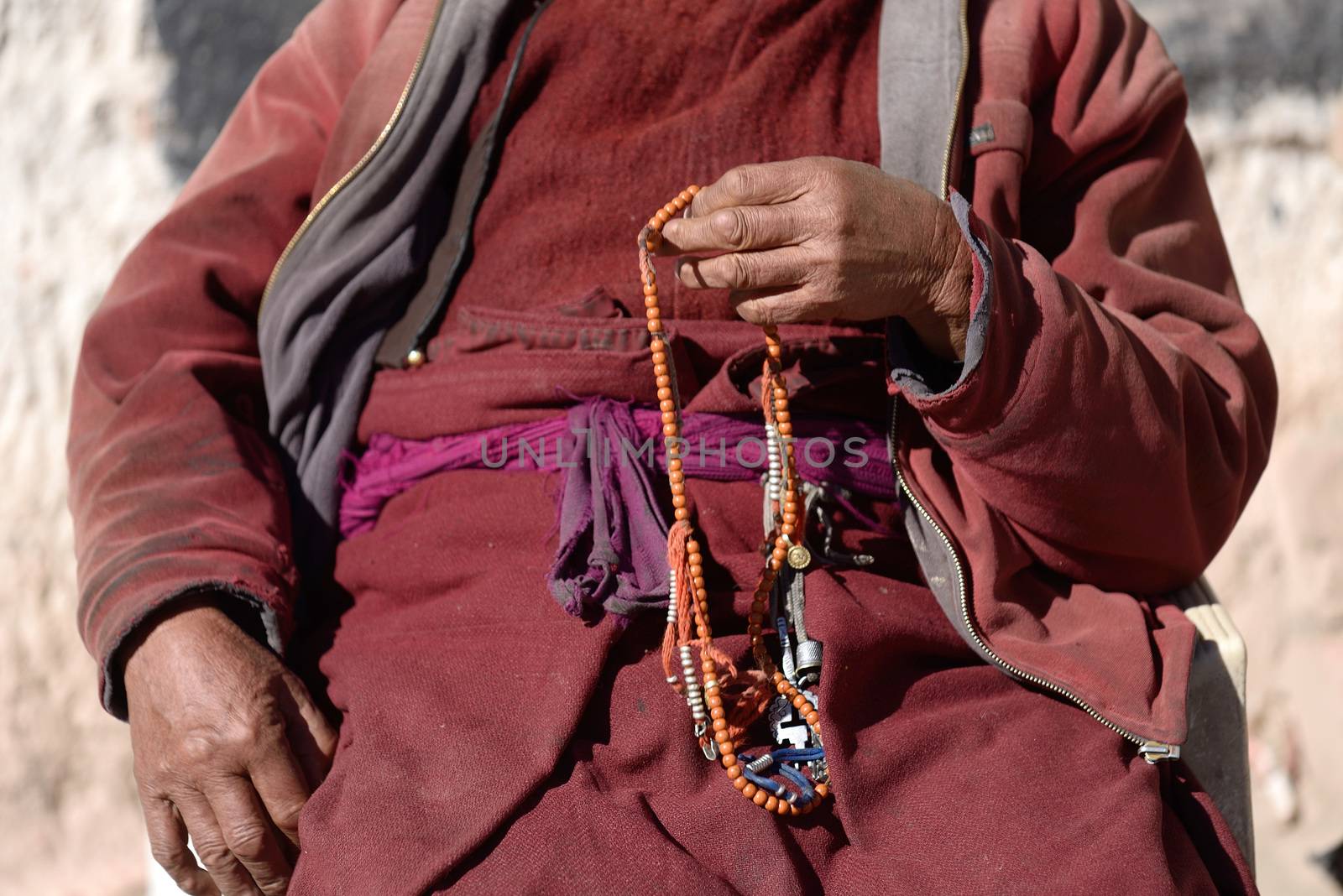 Prayer beads in monk's hand by think4photop