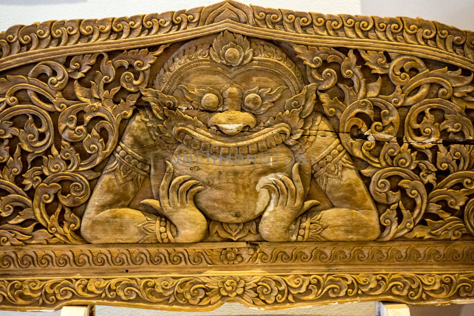 detail of wood carving with thai pattern on natural wood plate for decorated temple,Thailand