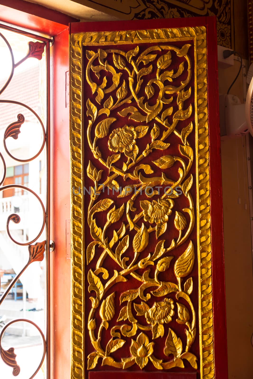 detail of wood carving with thai pattern on natural wood plate for decorated temple,Thailand