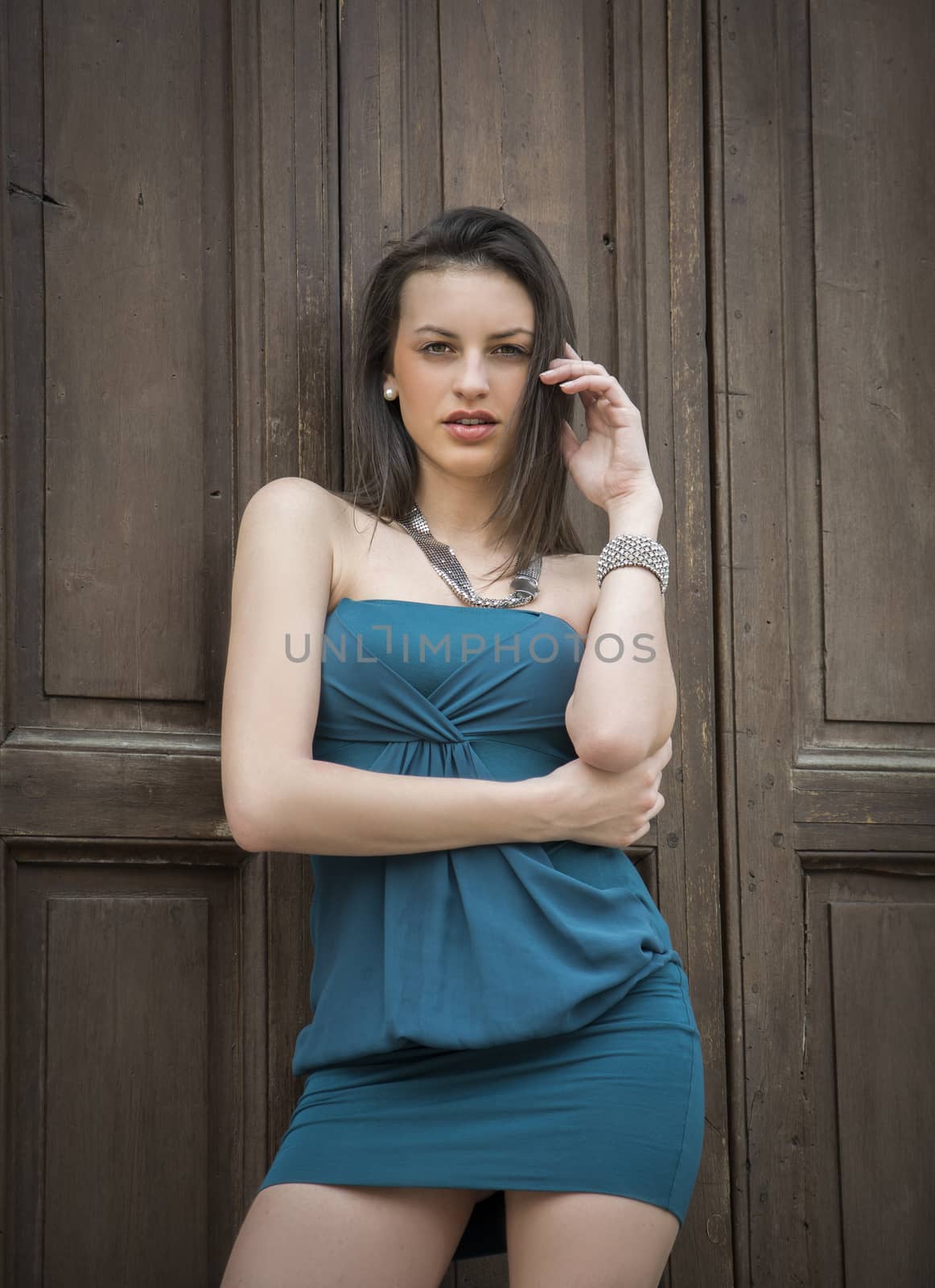 Elegant attractive young woman against wood door by artofphoto