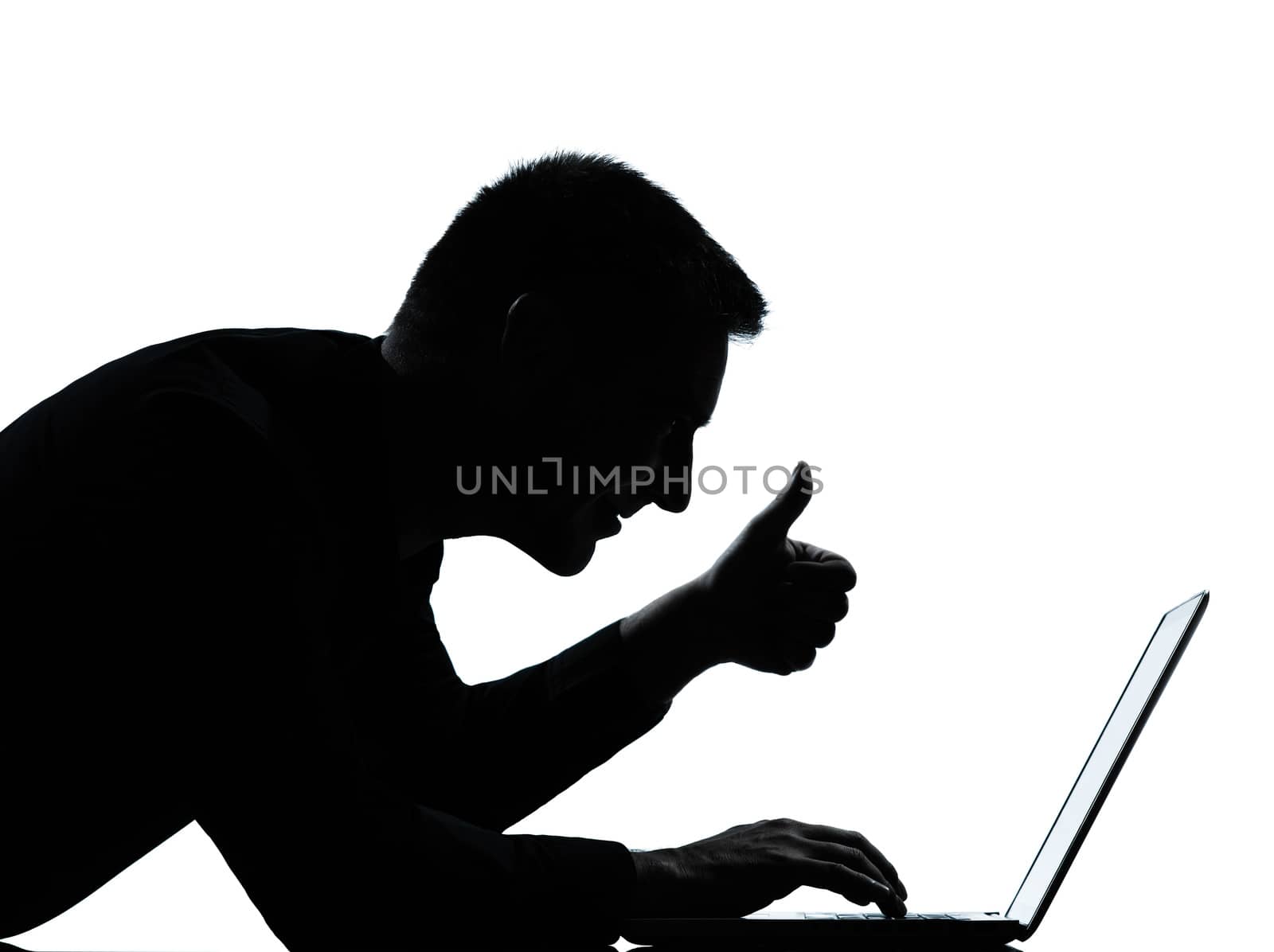 one  business man computing computer laptop thumb up portrait silhouette in studio isolated on white background