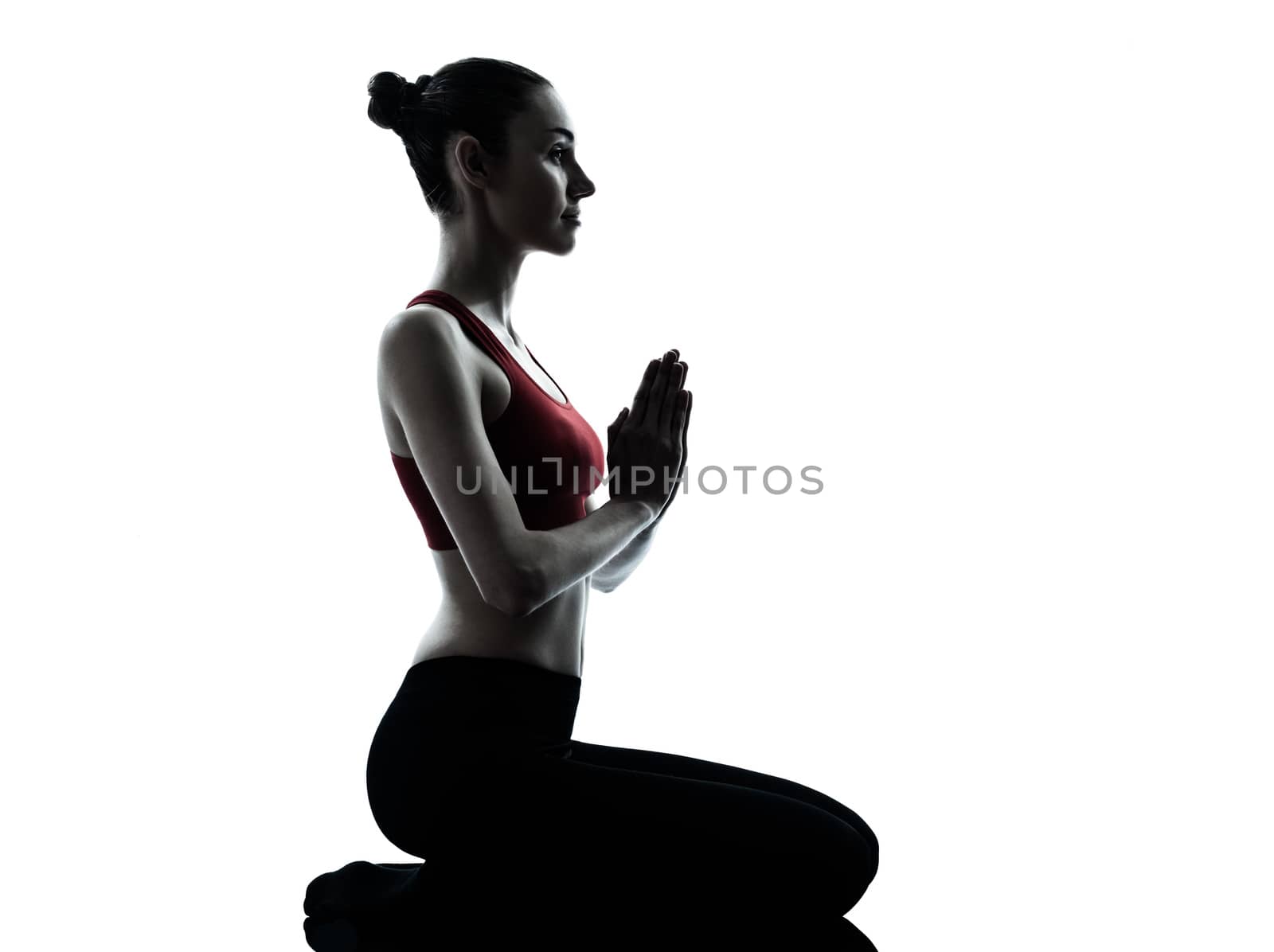 one  woman exercising yoga meditating in silhouette studio isolated on white background