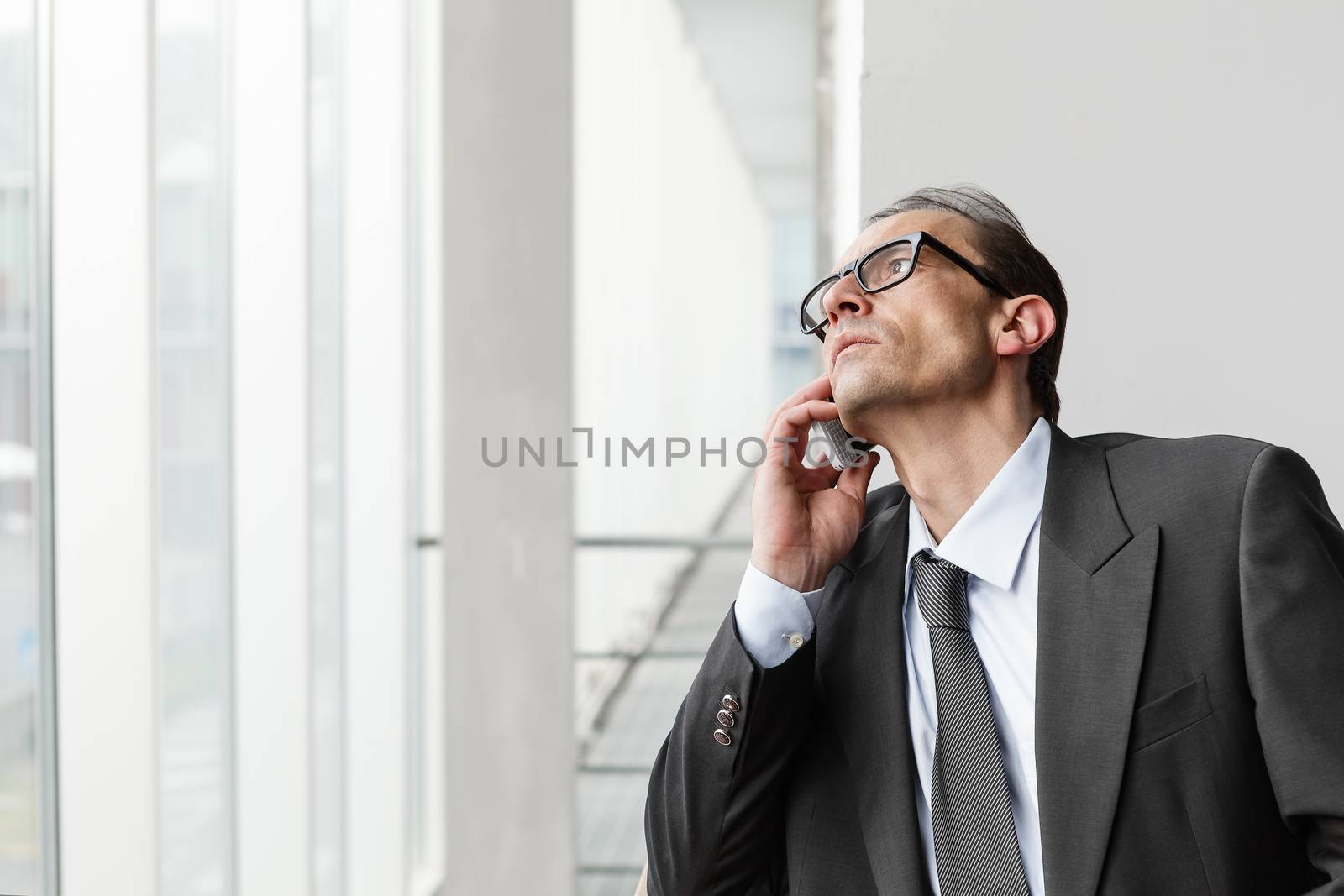 Eyeglasses Adult businessman talking on phone and waiting for