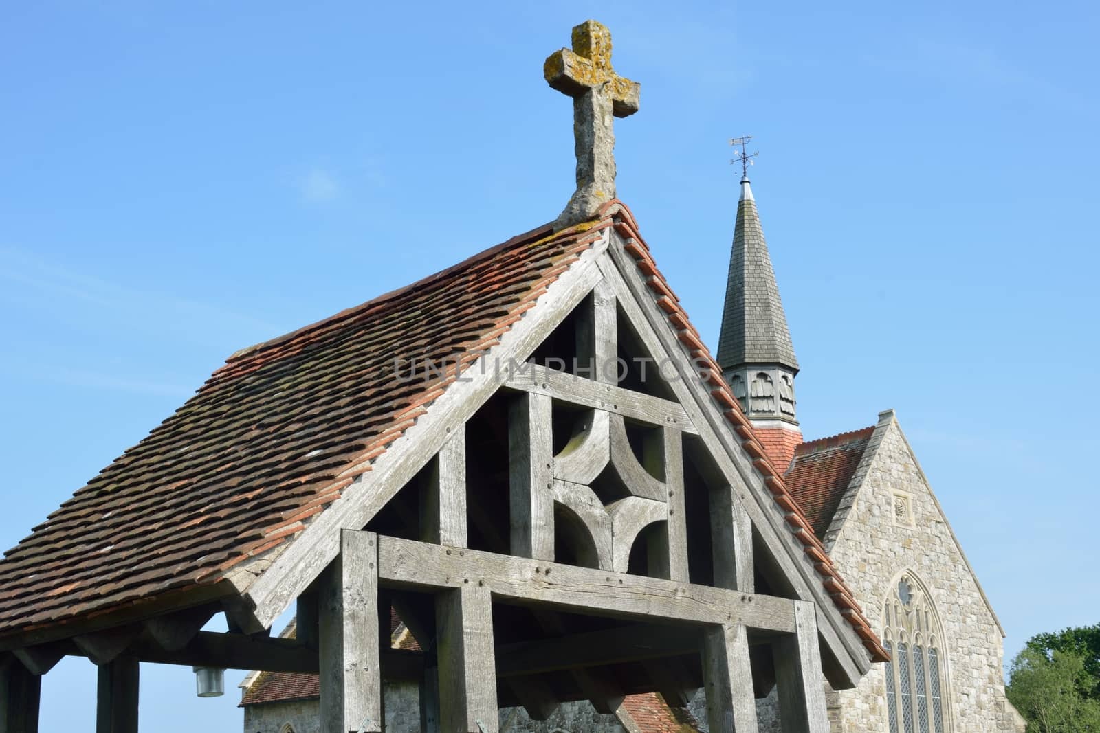 Wooden lychgate with church in background