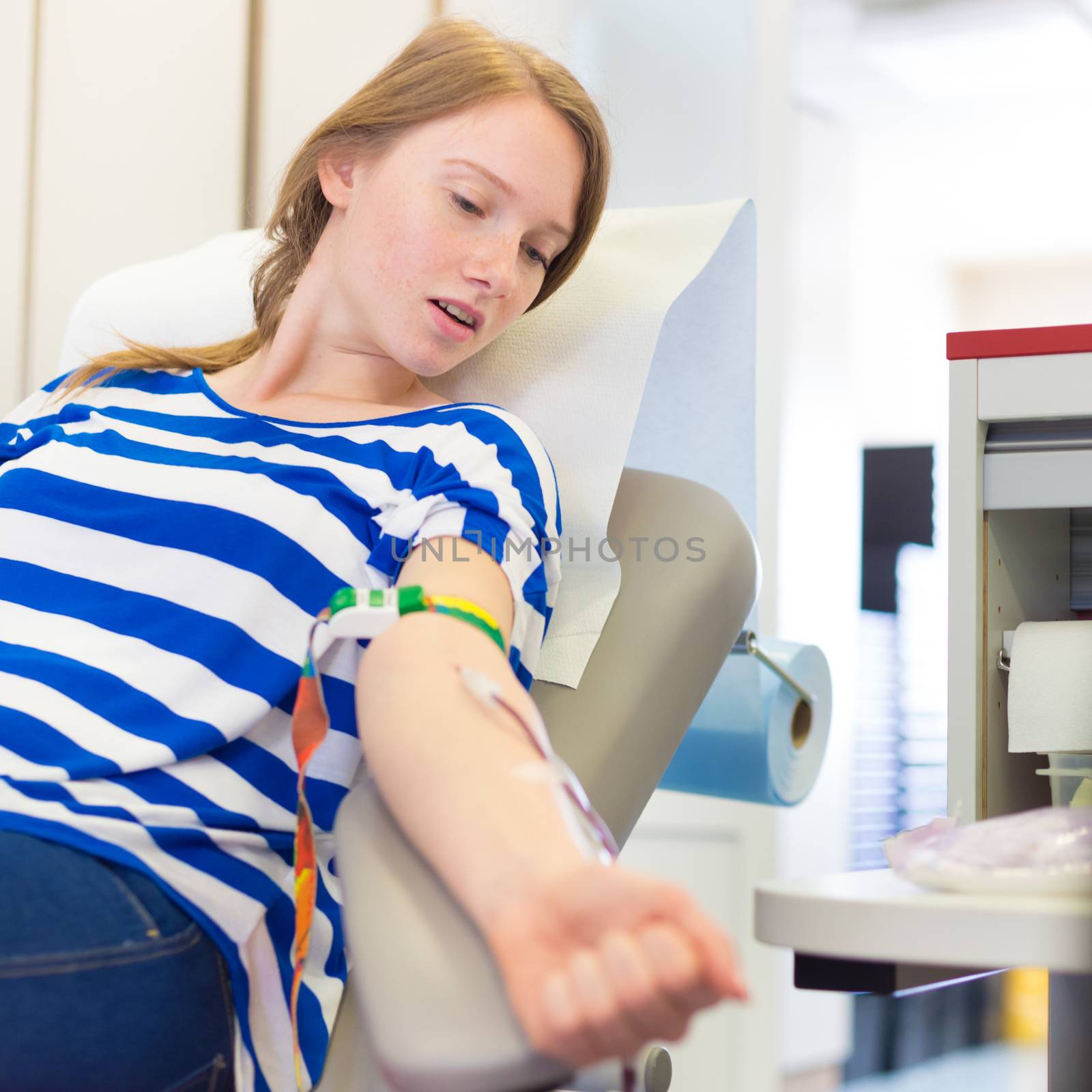 Young blood donor at donation.