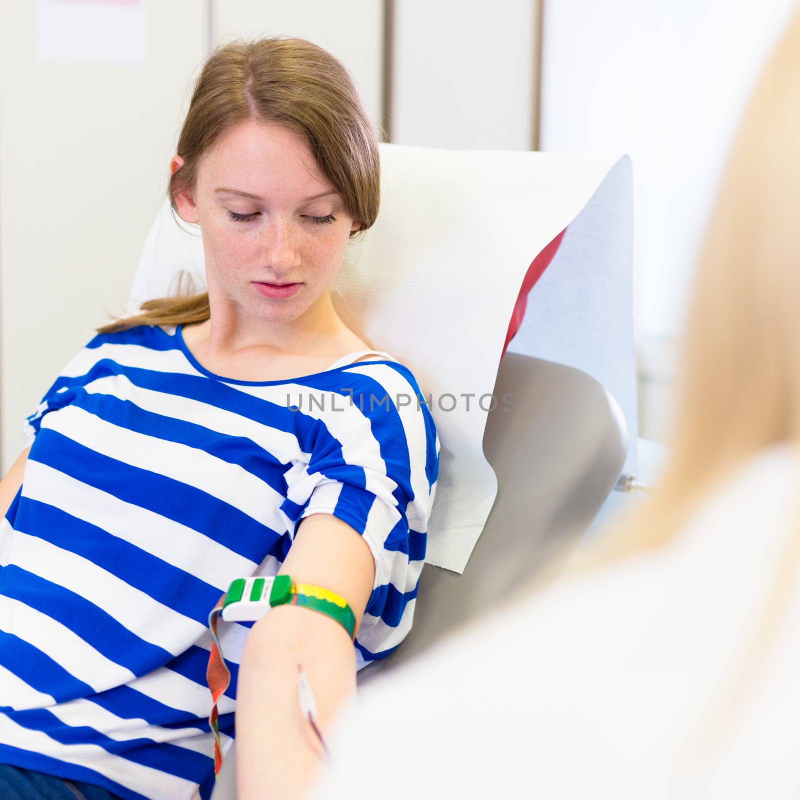 Young blood donor at donation.