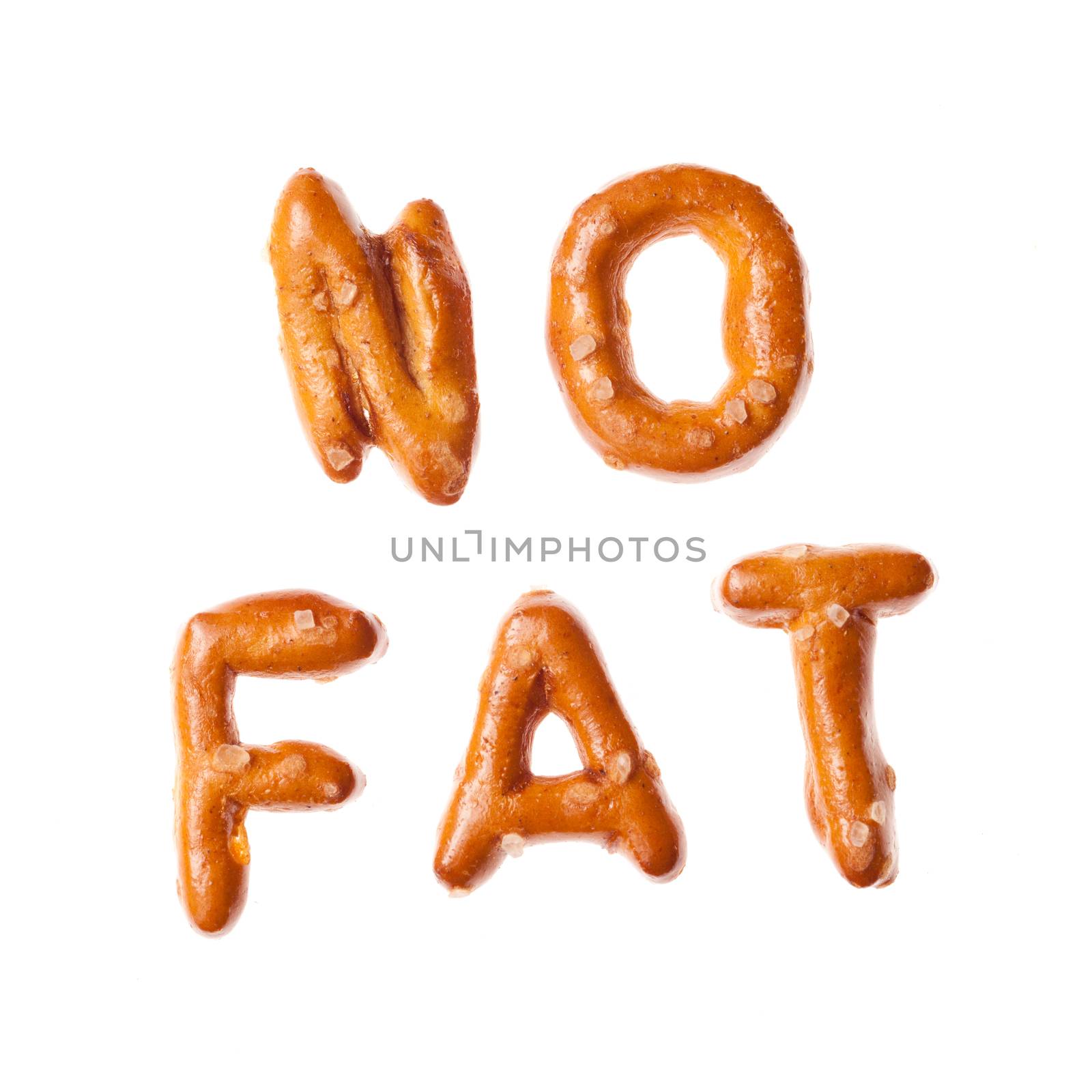 Words NO FAT written, laid-out, with crispy alphabet letter pretzels isolated on white background