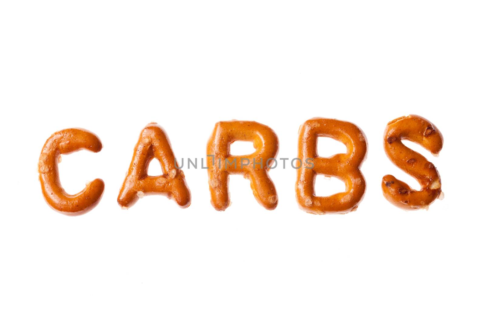 Word CARBS written, laid-out, with crispy alphabet pretzels isolated on white background