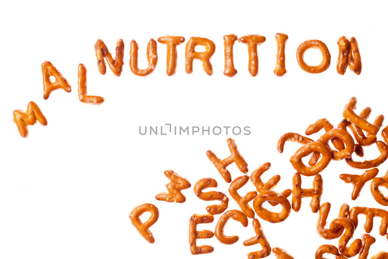 Word NUTRITION written, laid-out, with crispy alphabet pretzels and a group of them isolated on white background