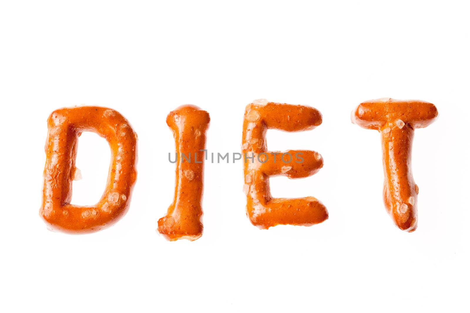 Word DIET written, laid-out, with crispy alphabet pretzels isolated on white background