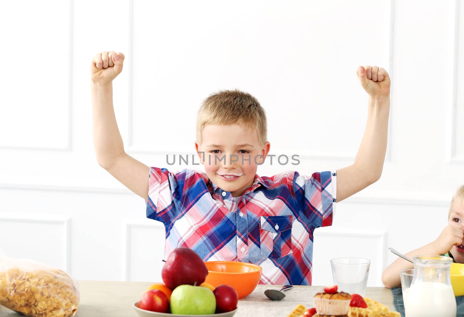 Family, breakfast. Happy boy by the table