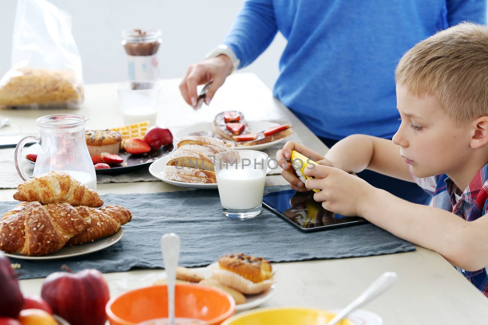 Mother with kid during family breakfast