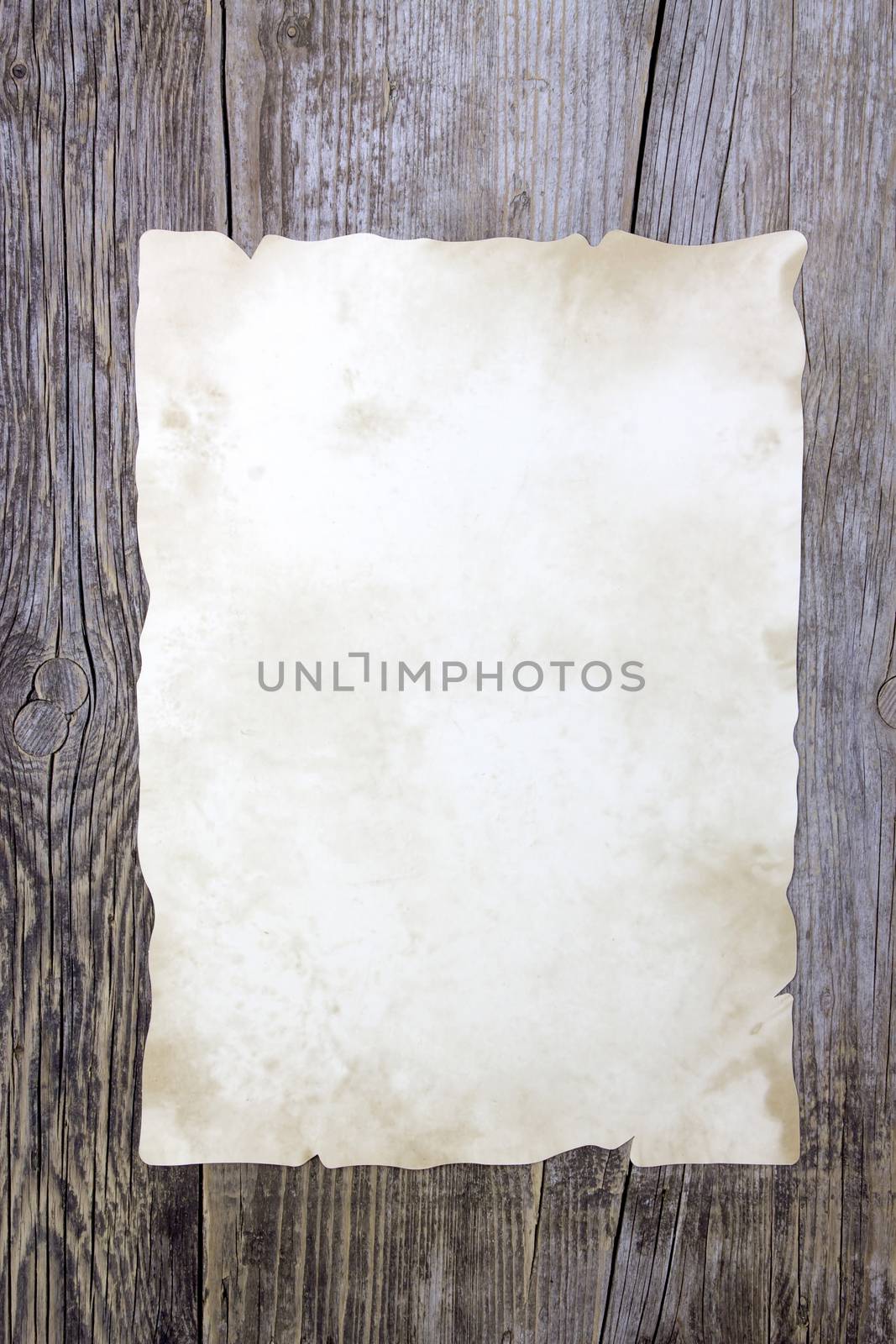 Old paper sheet on wooden background  by miradrozdowski