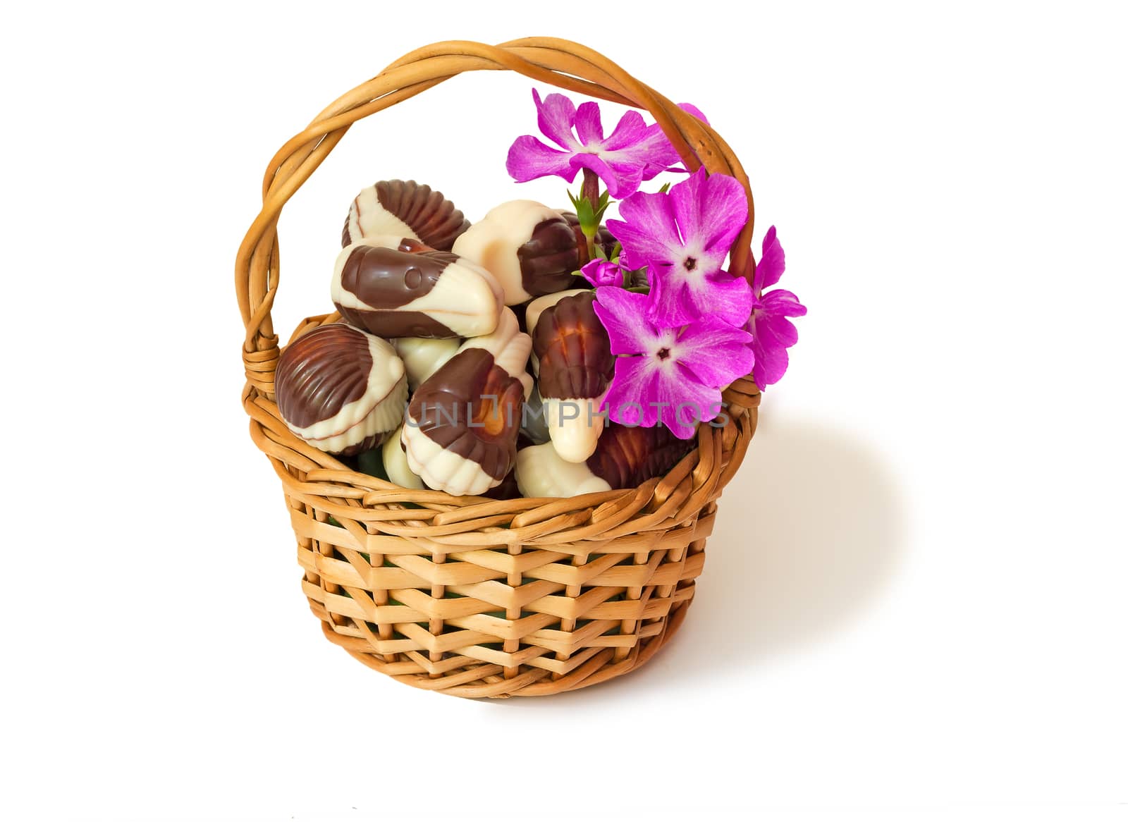 Chocolates in a wattled basket on a white background. by georgina198