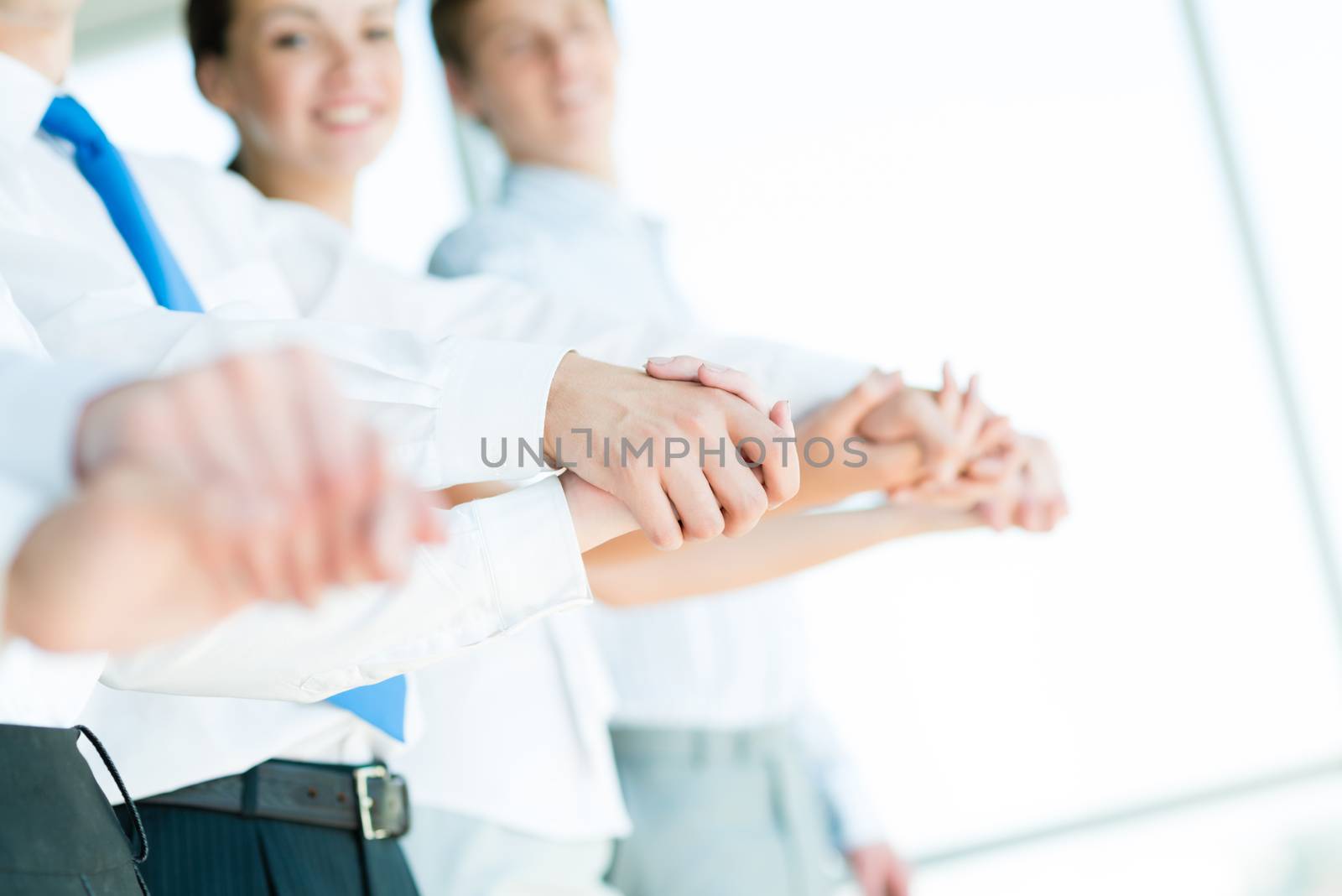 hands of businessmen, businessmen hold hands, stand in a row, the concept of teamwork