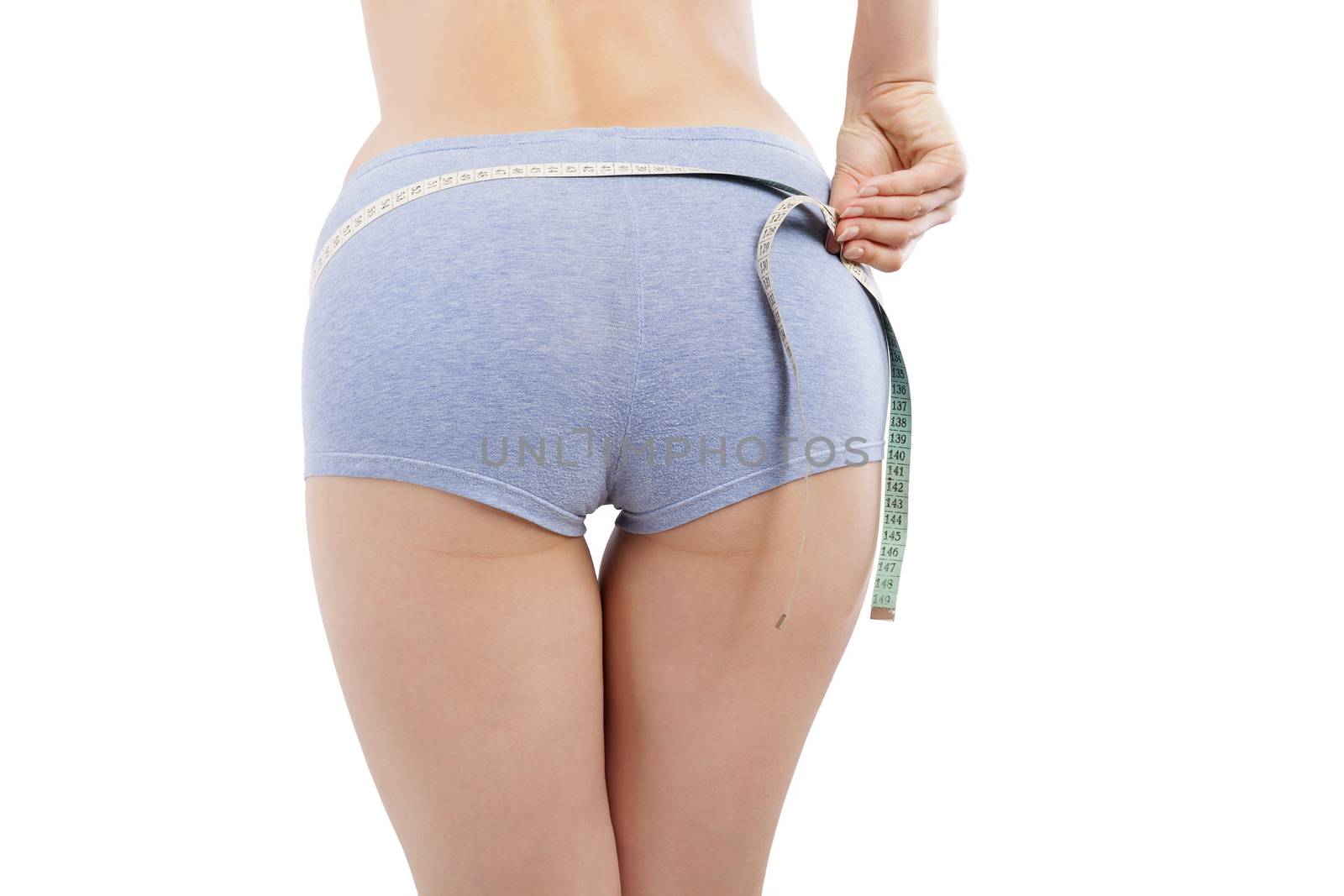 Diet and detox. Girl measuring her beautiful sexy butt in panties with measure tape isolated on white background. Weight loss concept.