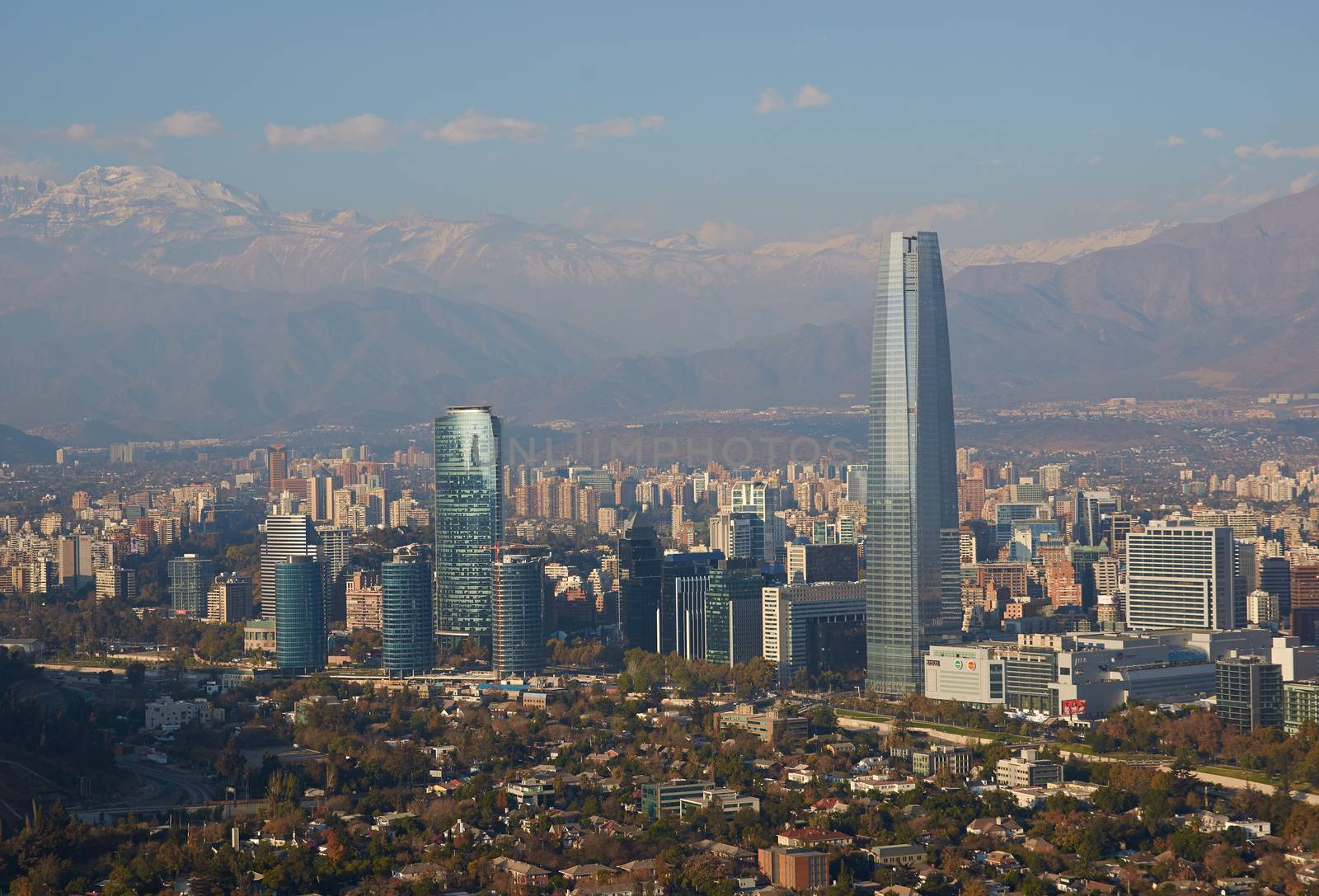 Modern office and apartment blocks of Santiago in Chile against the backdrop of the snow capped mountains of the Andes.