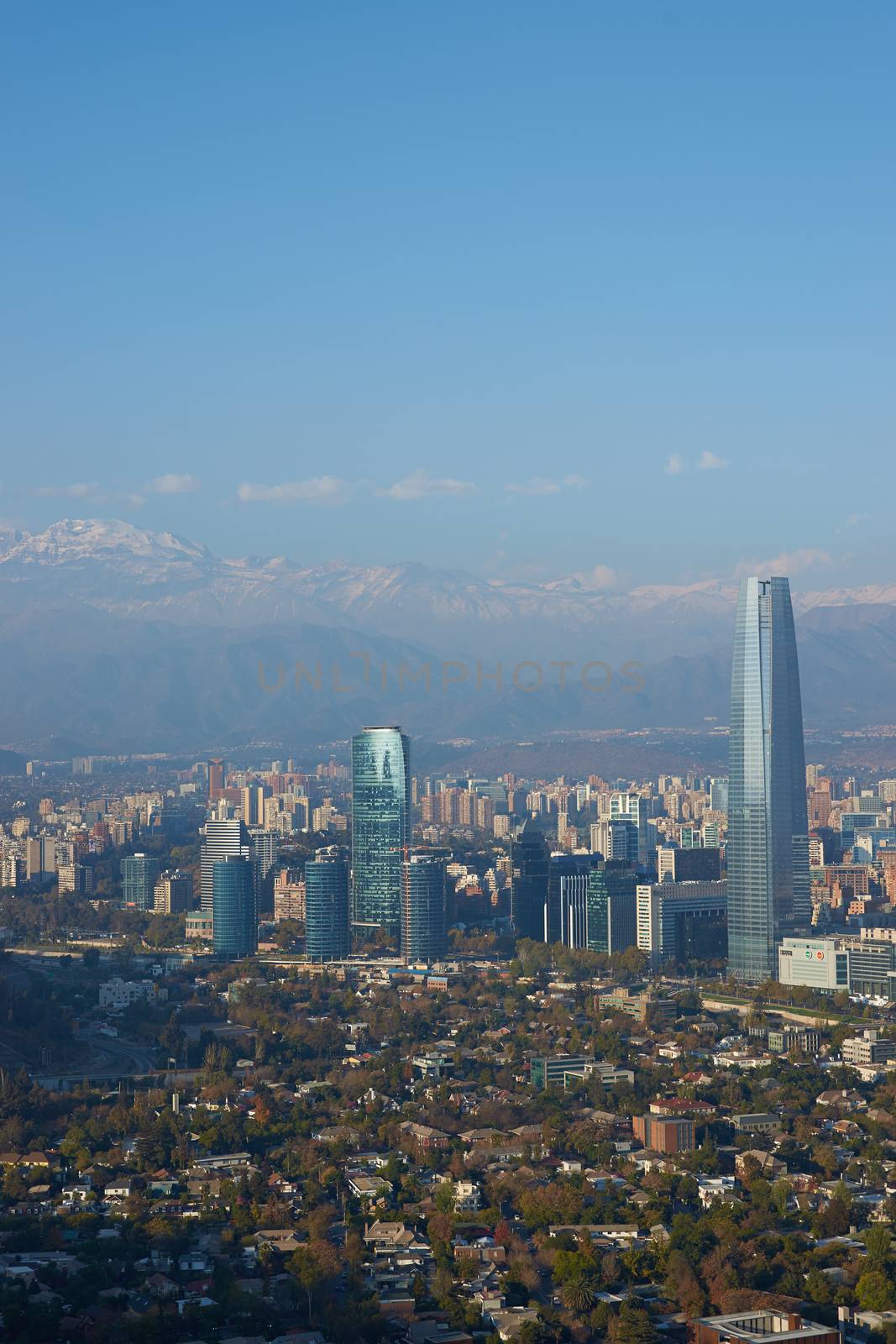 Modern office and apartment blocks of Santiago in Chile against the backdrop of the snow capped mountains of the Andes.