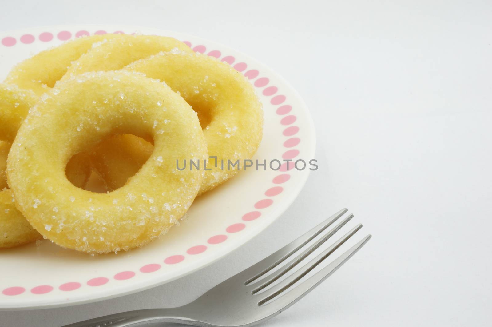 Donuts on a plate with fork by eaglesky