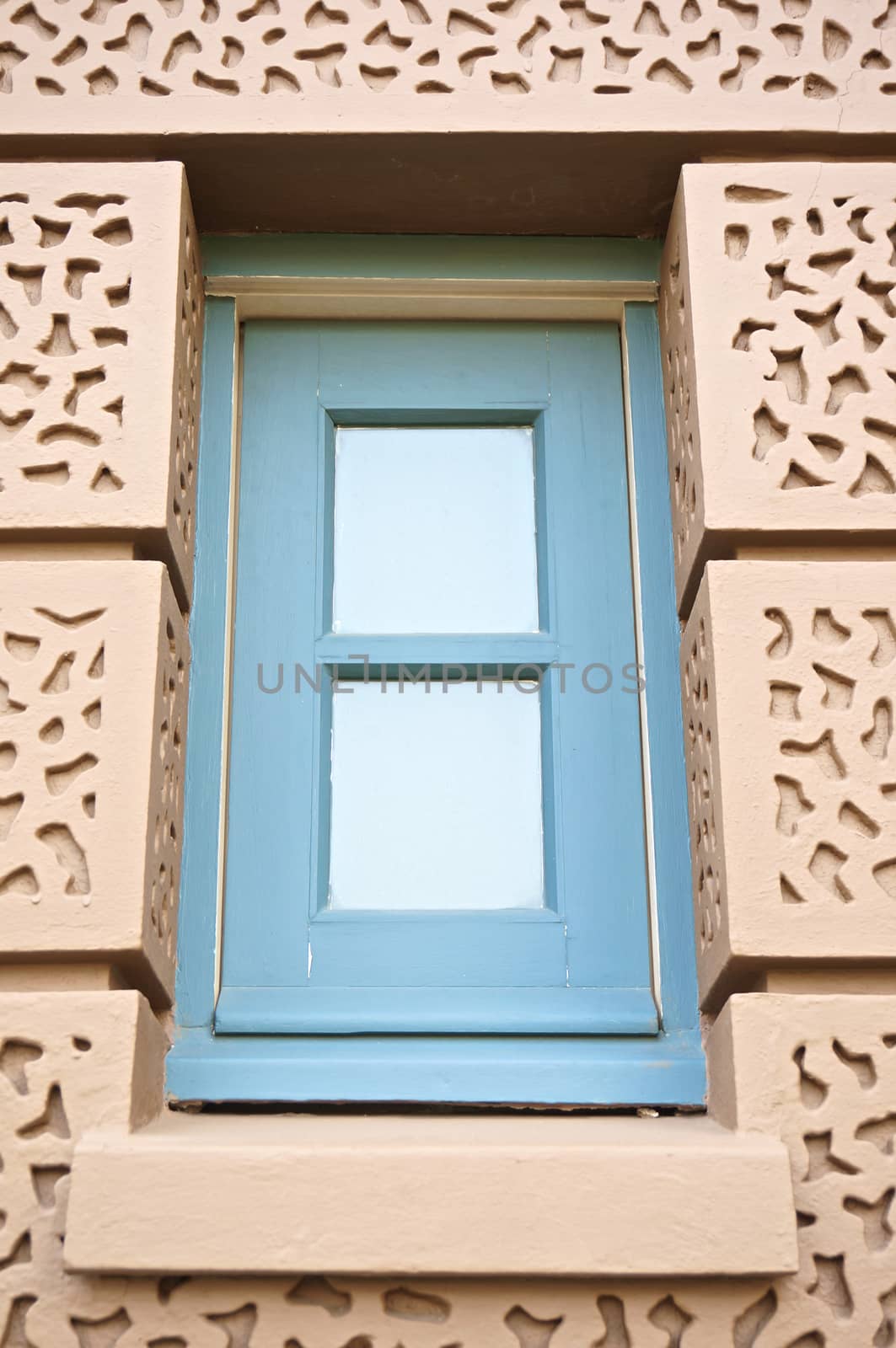 Blue square window in brown wall at Grand Palace by eaglesky