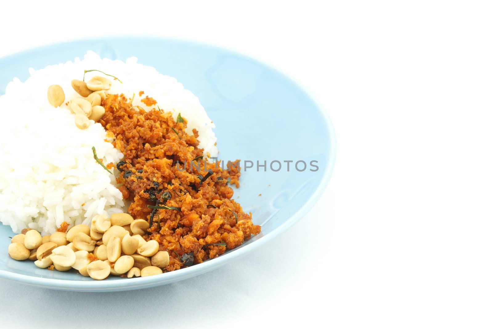 Rice and fried tofu with black pepper, peanuts look like crispy catfish vegetarian on dish with white background.