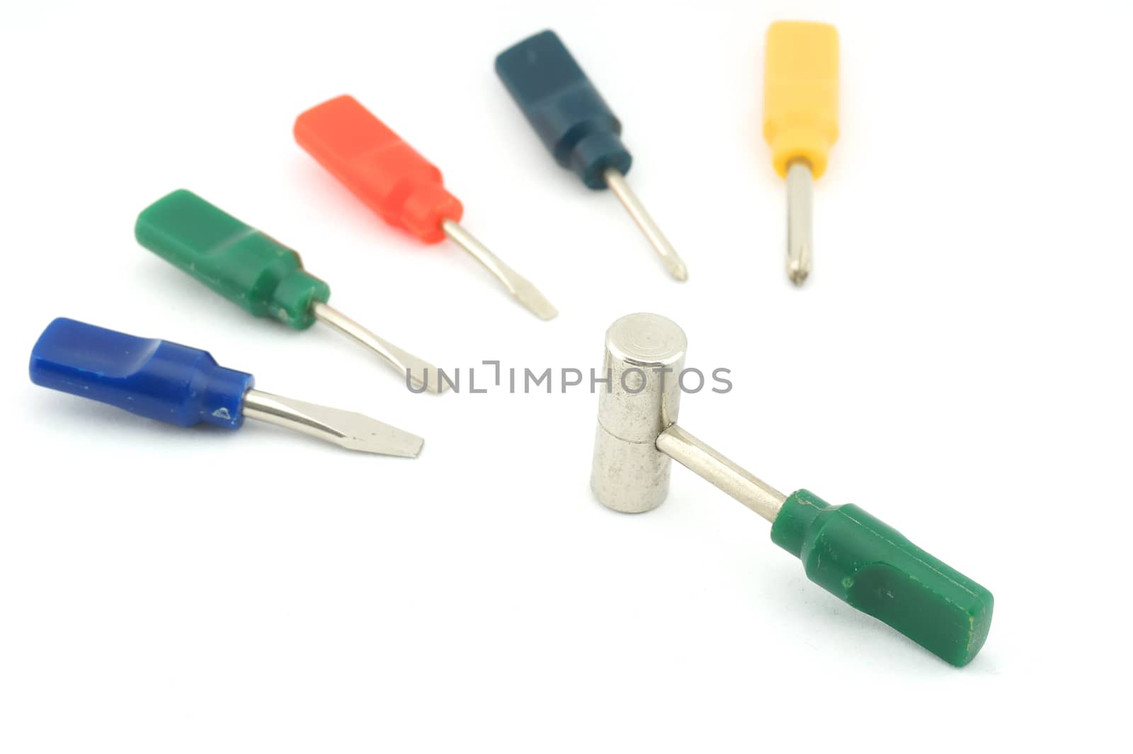Colorful small screwdriver and a hammer use for minor repair with white background.