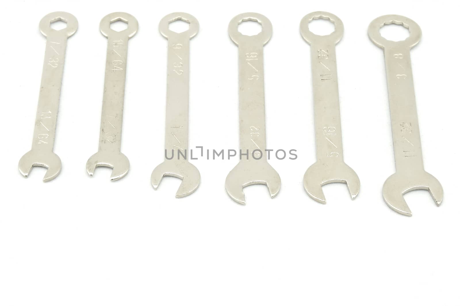 Multi sizes of Wrench use for minor repair arranged on white background.