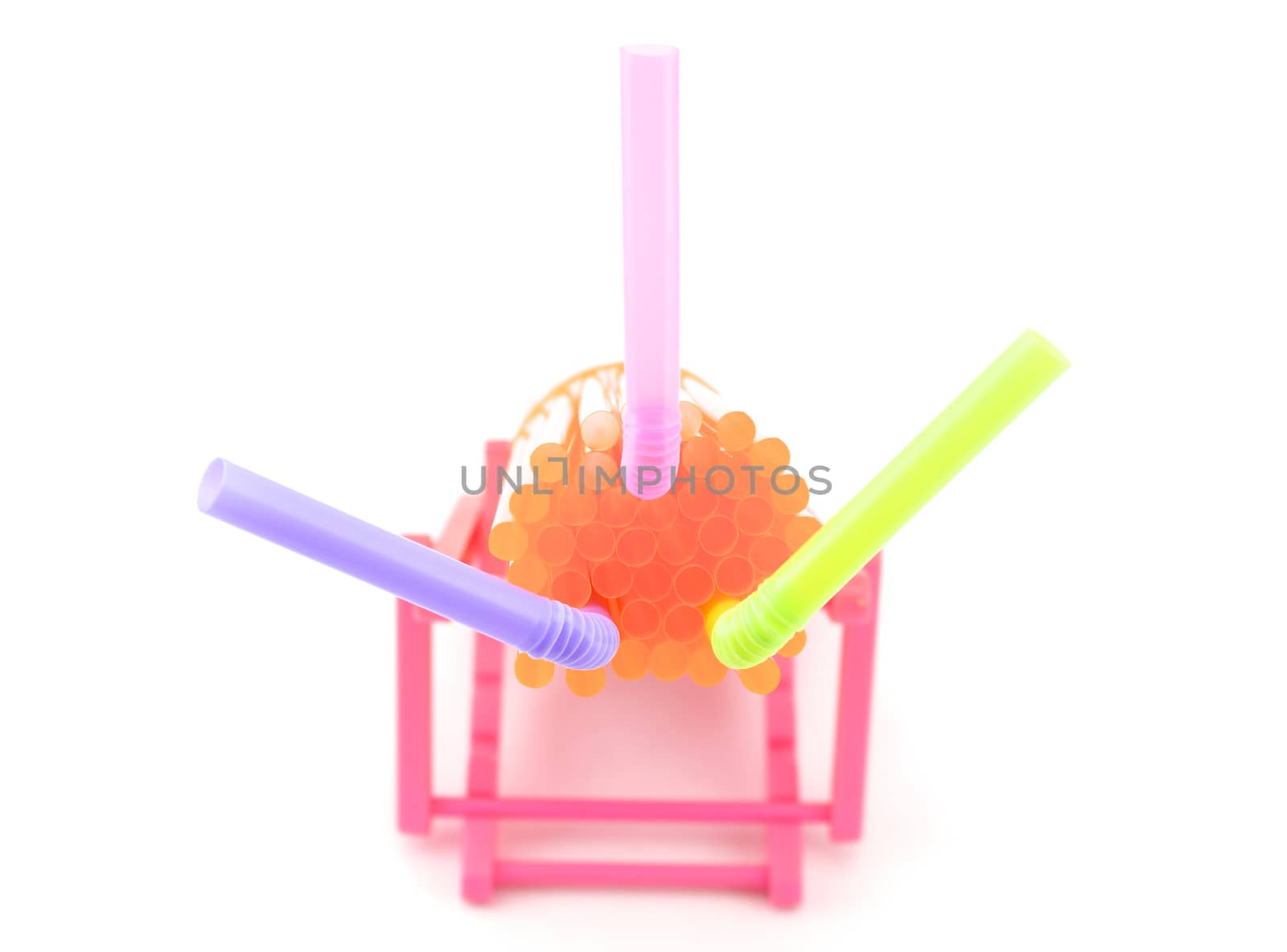 Orange straw clump and flexible purple, pink and green straw inserted. Put on a white background.