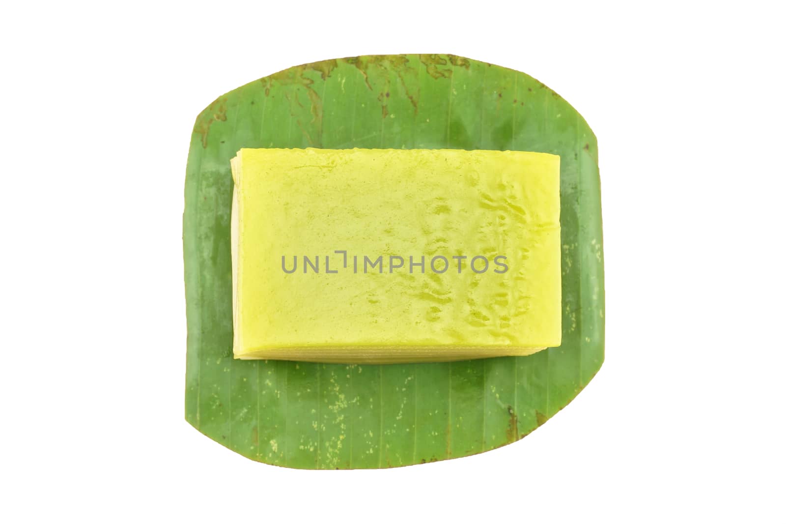 Thai layer cake on a banana leaf green isolated with white background.