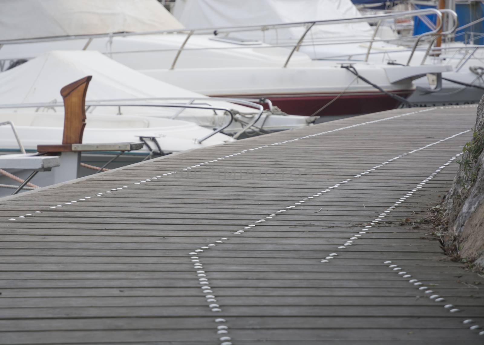 Small boat marina tight view with boardwalk background copy space. Mallorca, Balearic islands, Spain.