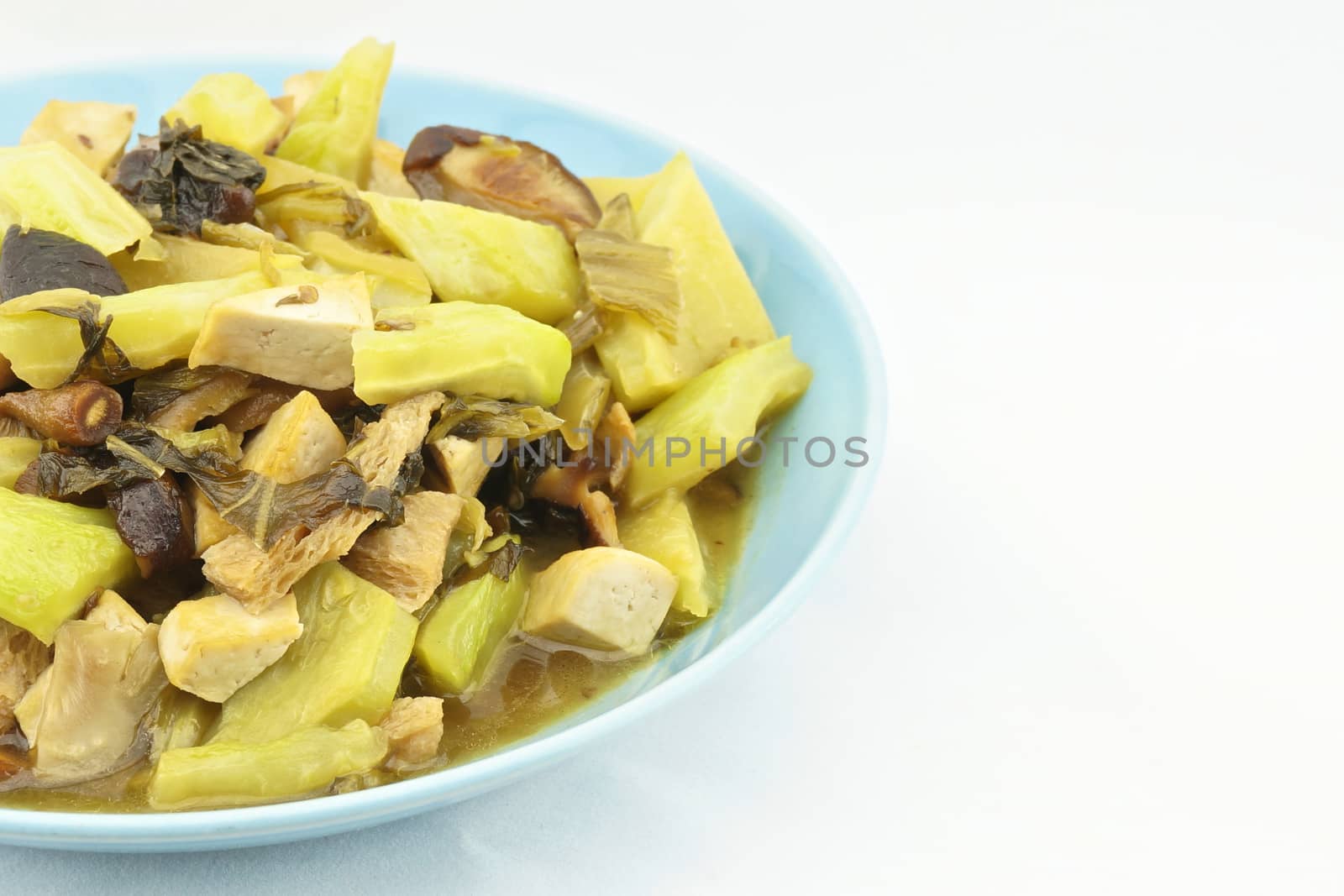 Bitter gourd fried pickle and mushroom is a healthy vegetarian with white background.