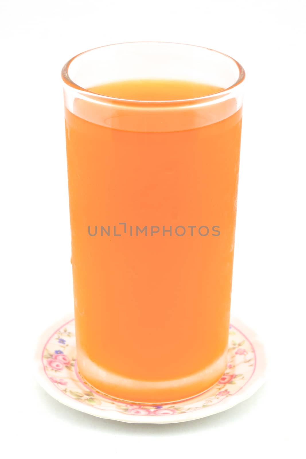 Cold orange juice in glass placed on coasters with white background.