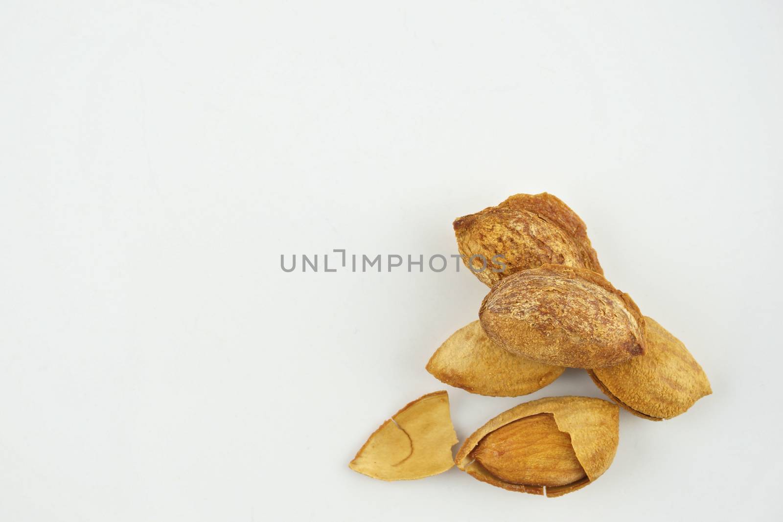 Almond with hull and husk isolated by eaglesky