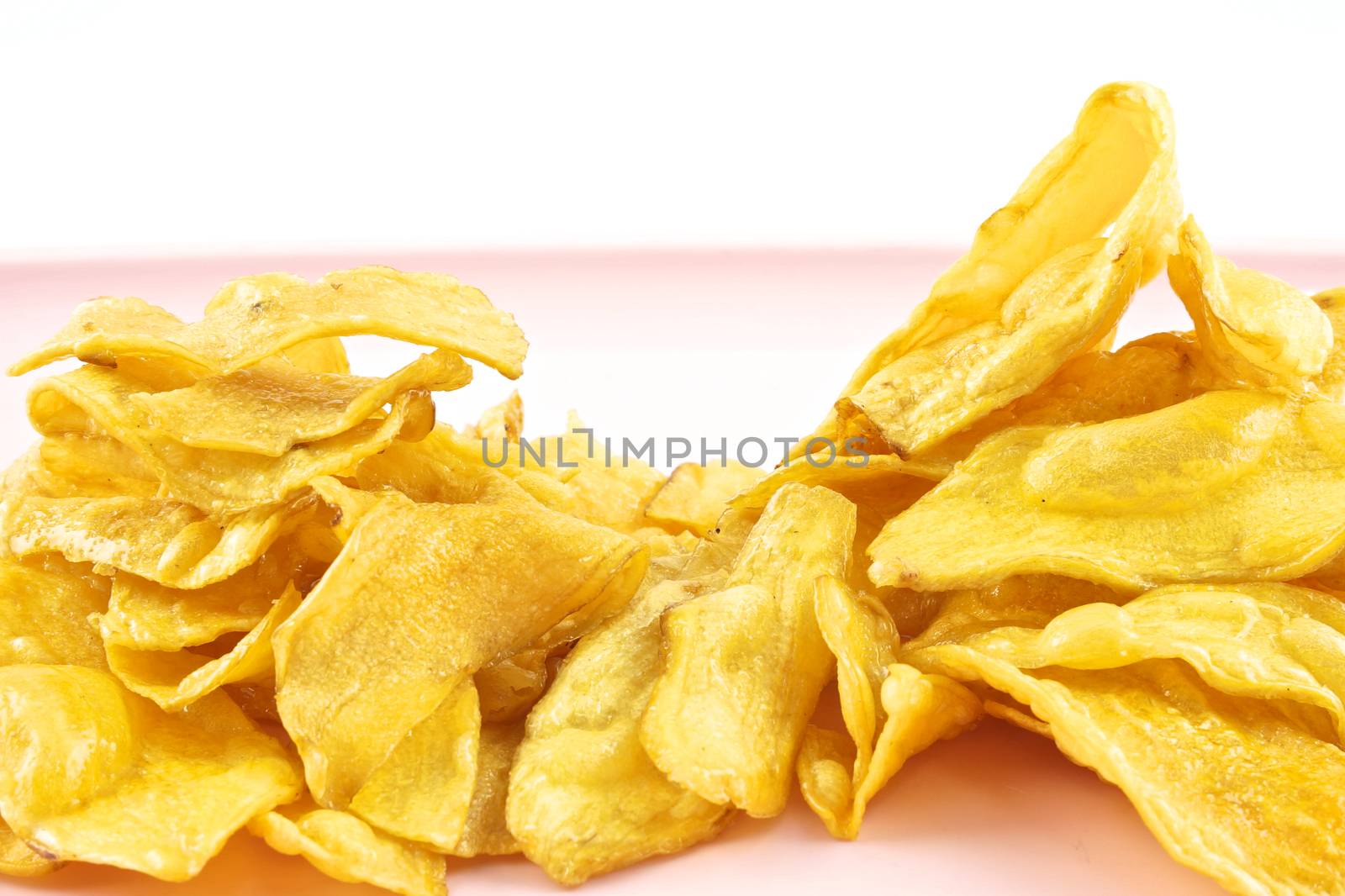 Sliced yellow cassava fried and coating sugar paste as mountain.