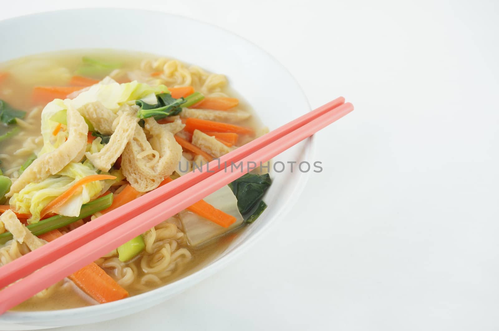 Egg noodle and clear soup vegetarian with chopsticks by eaglesky