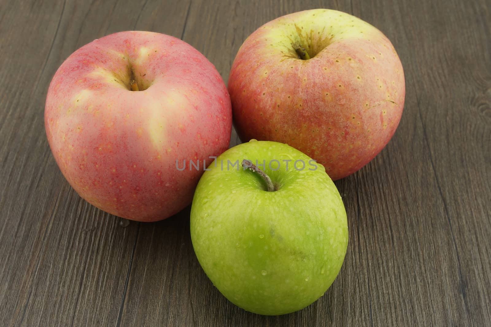 Fresh red and green apples on dark brown wood by eaglesky