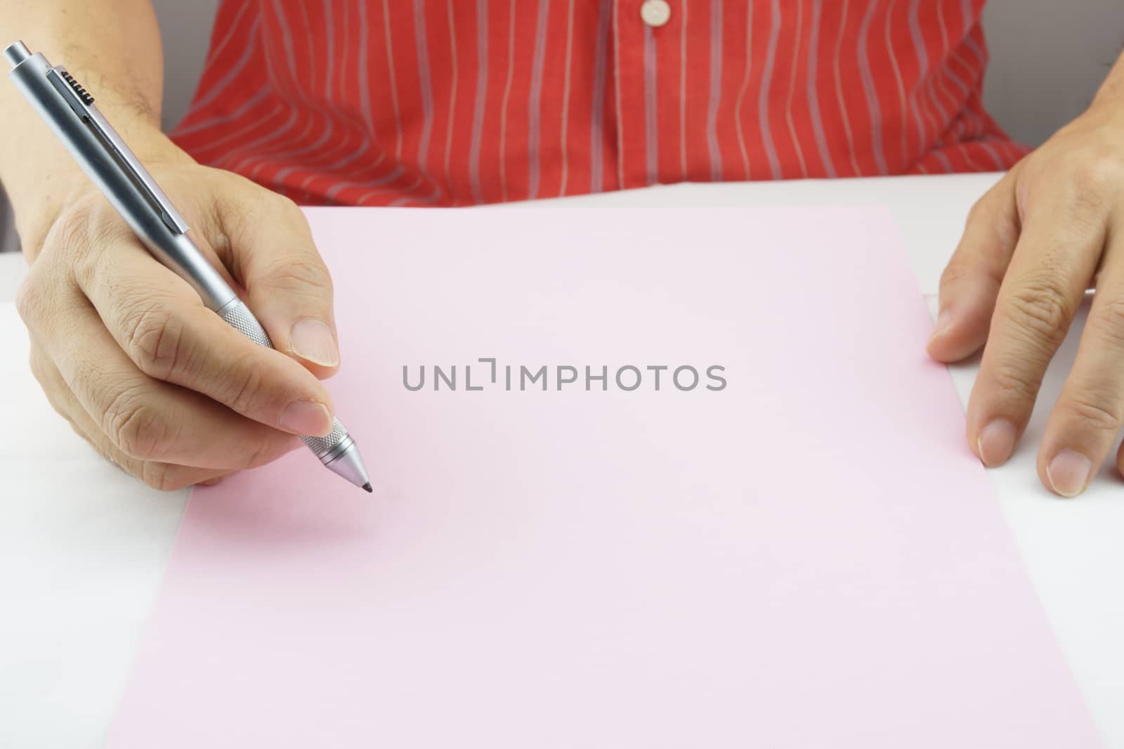 Man planning business on pink paper by eaglesky