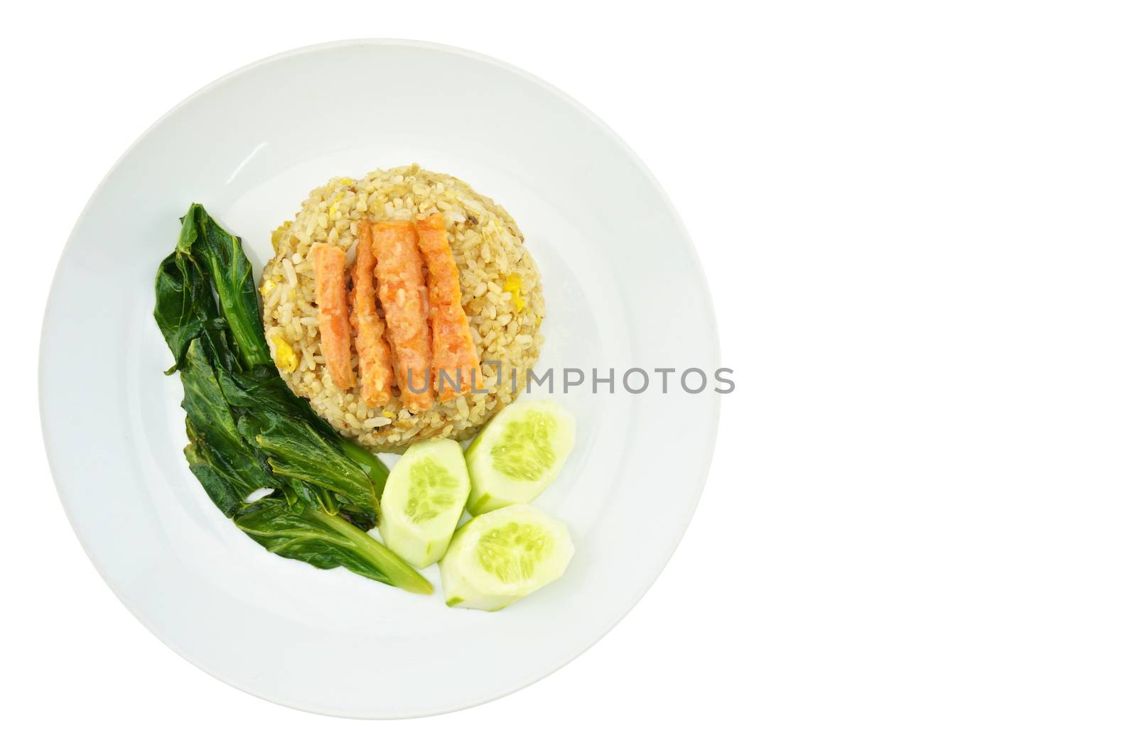 Shrimp fried rice vegetarian with kale, carrots and cucumber on a plate isolated with white background.