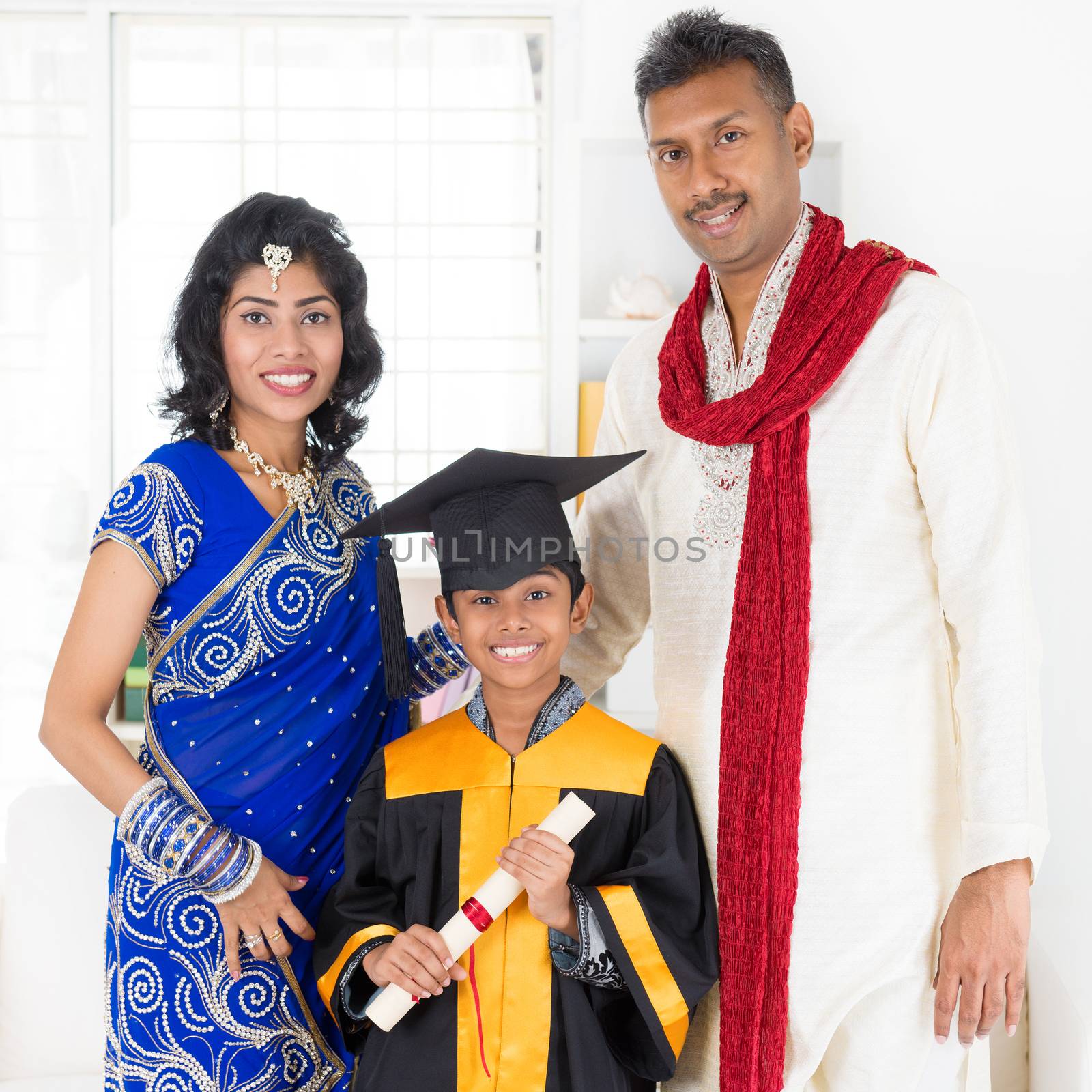 Kindergarten graduation. Asian Indian family, parents and child on kinder graduate day.