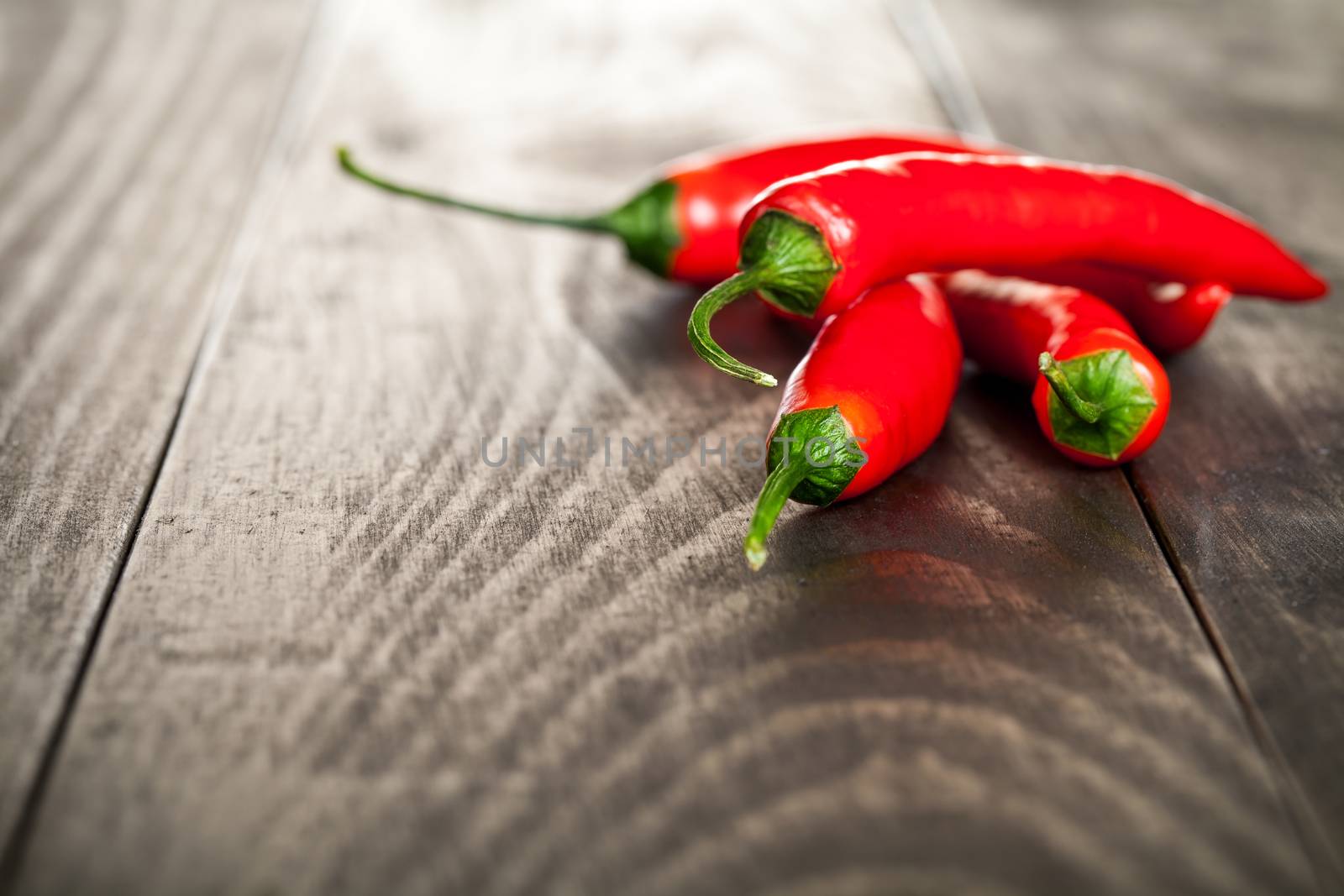 Red hot chilli pepper on wooden table background